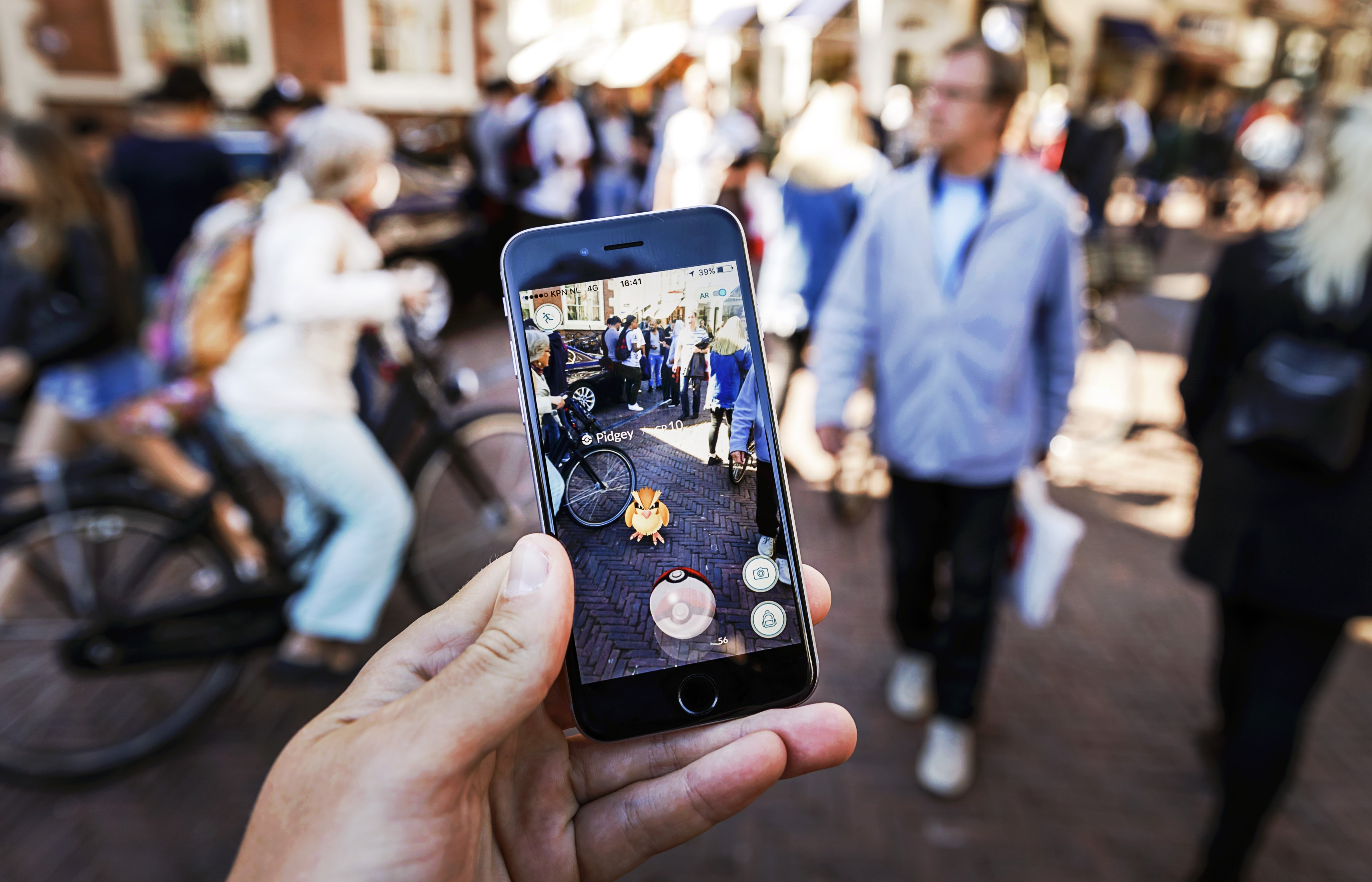 Gamers play with the Pokemon Go application on their mobile phone, at the Grote Markt in Haarlem, on July 13, 2016. (Remko De Waal—AFP/Getty Images)