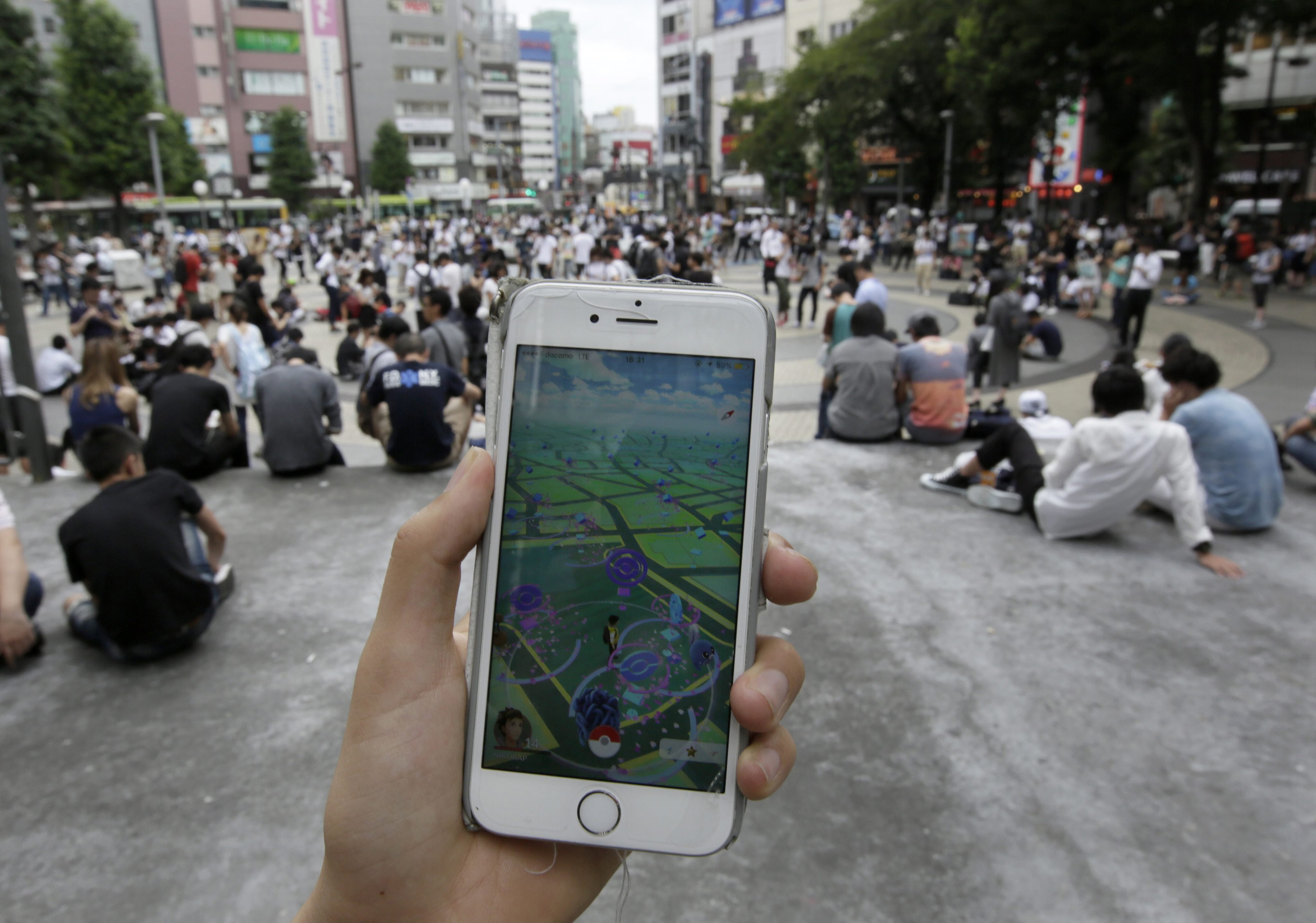 People crowd square to play Pokemon Go