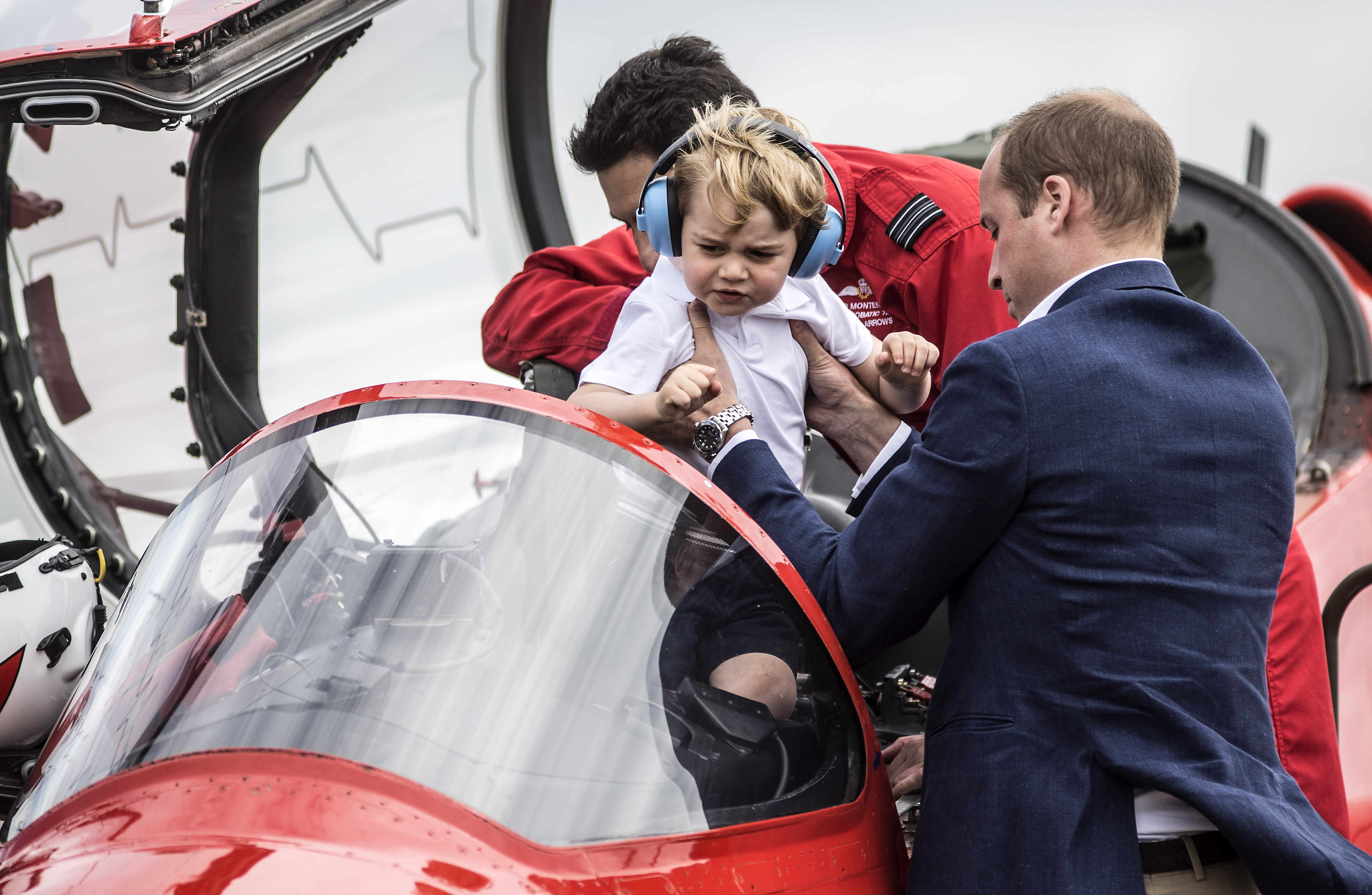 FAIRFORD, WALES - JULY 08: Prince Willliam, Duke of Cambridge lifts Prince George out of the cockpit of a red arrows plane during their visit to the Royal International Air Tattoo at RAF Fairford on July 8, 2016 in Fairford, England.  (Photo by Richard Pohle - WPA Pool/Getty Images)