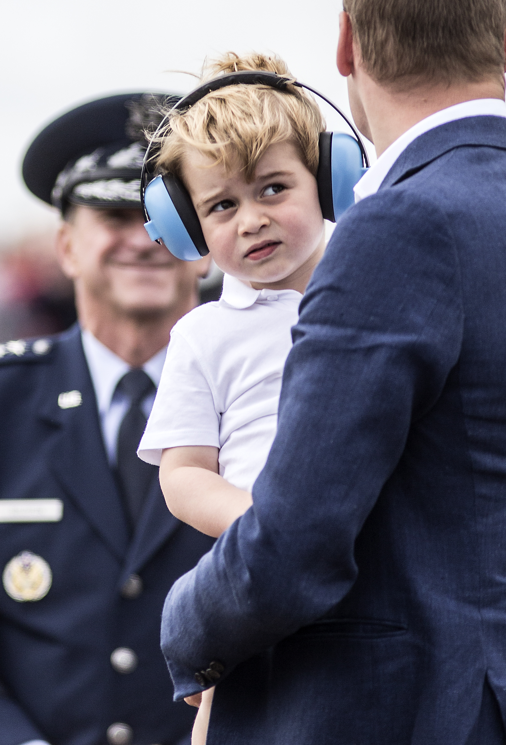 FAIRFORD, WALES - JULY 08: Prince George wears ear defenders as he is carried by Prince William, Duke of Cambridge during a visit to the Royal International Air Tattoo at RAF Fairford on July 8, 2016 in Fairford, England.  (Photo by Richard Pohle - WPA Pool/Getty Images)