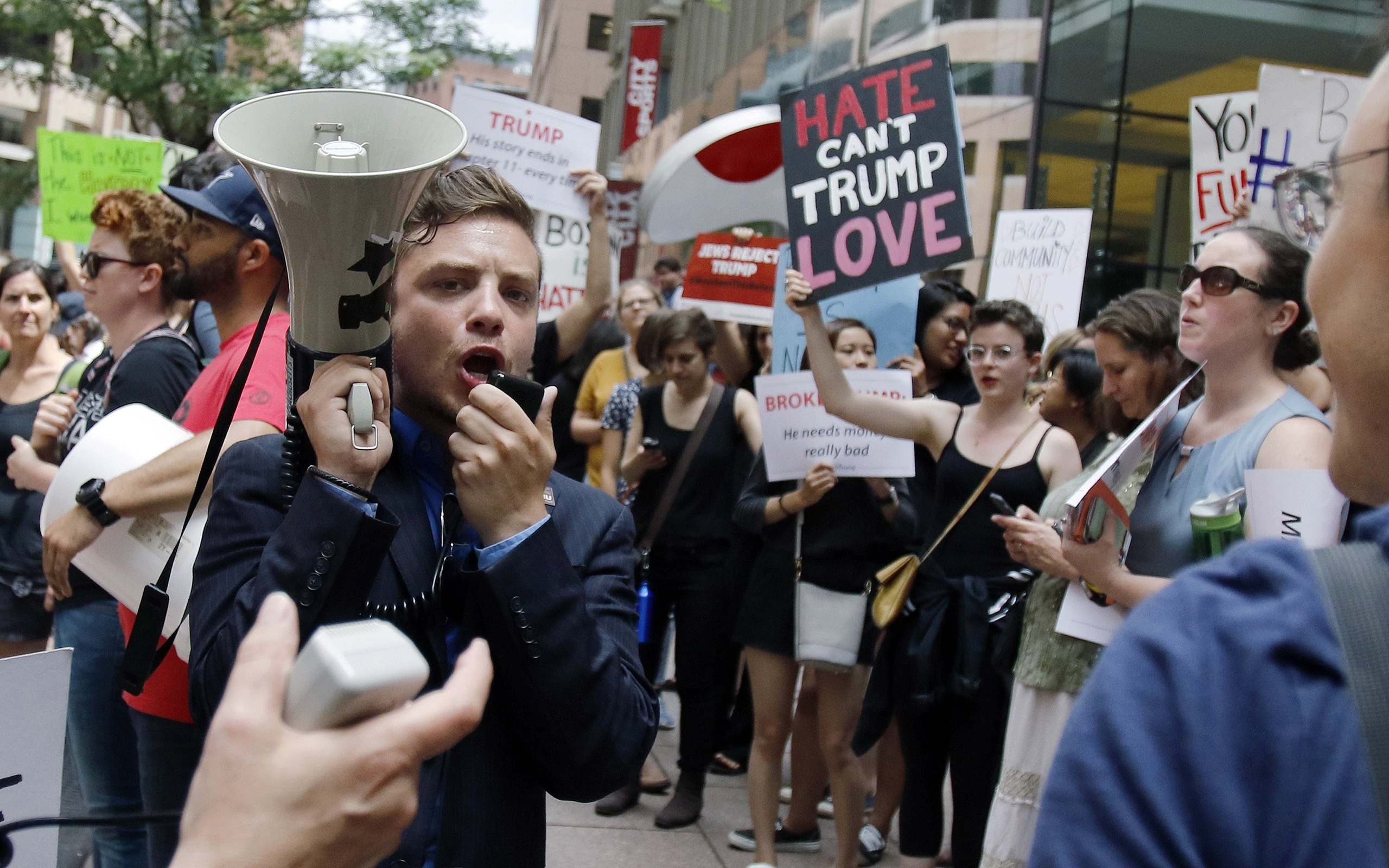 Protestors chant outside a downtown hotel where Donald Trump was holding a lunchtime fundraiser in Boston, June 29, 2016. (Bill Sikes—AP)