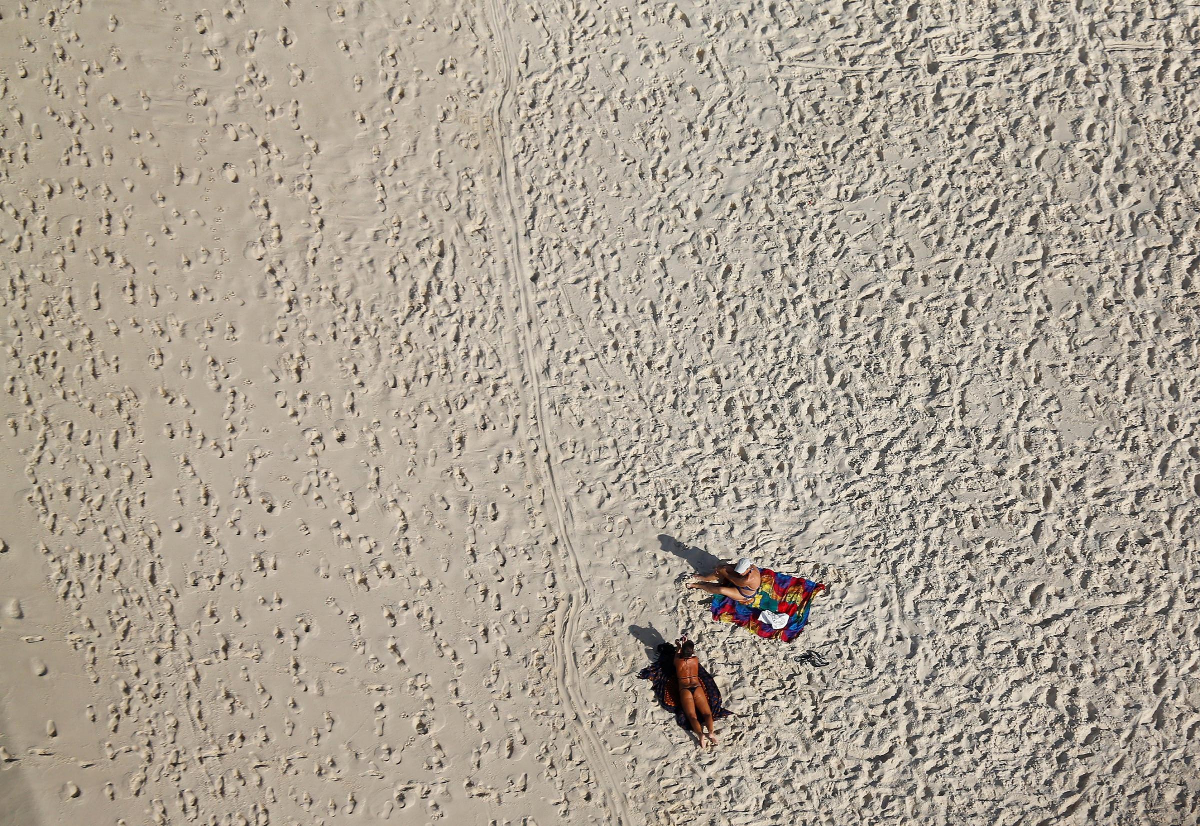 An aerial view shows people on Barra da Tijuca beach in Rio de Janeiro, July 16, 2016.