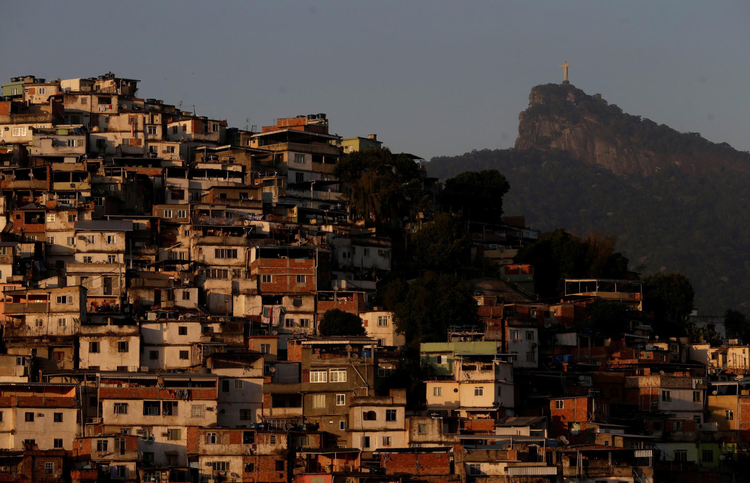 Christ the Redeemer is seen behind Morro da Coroa (Coroa slum) in Rio de Janeiro, July 13, 2016.