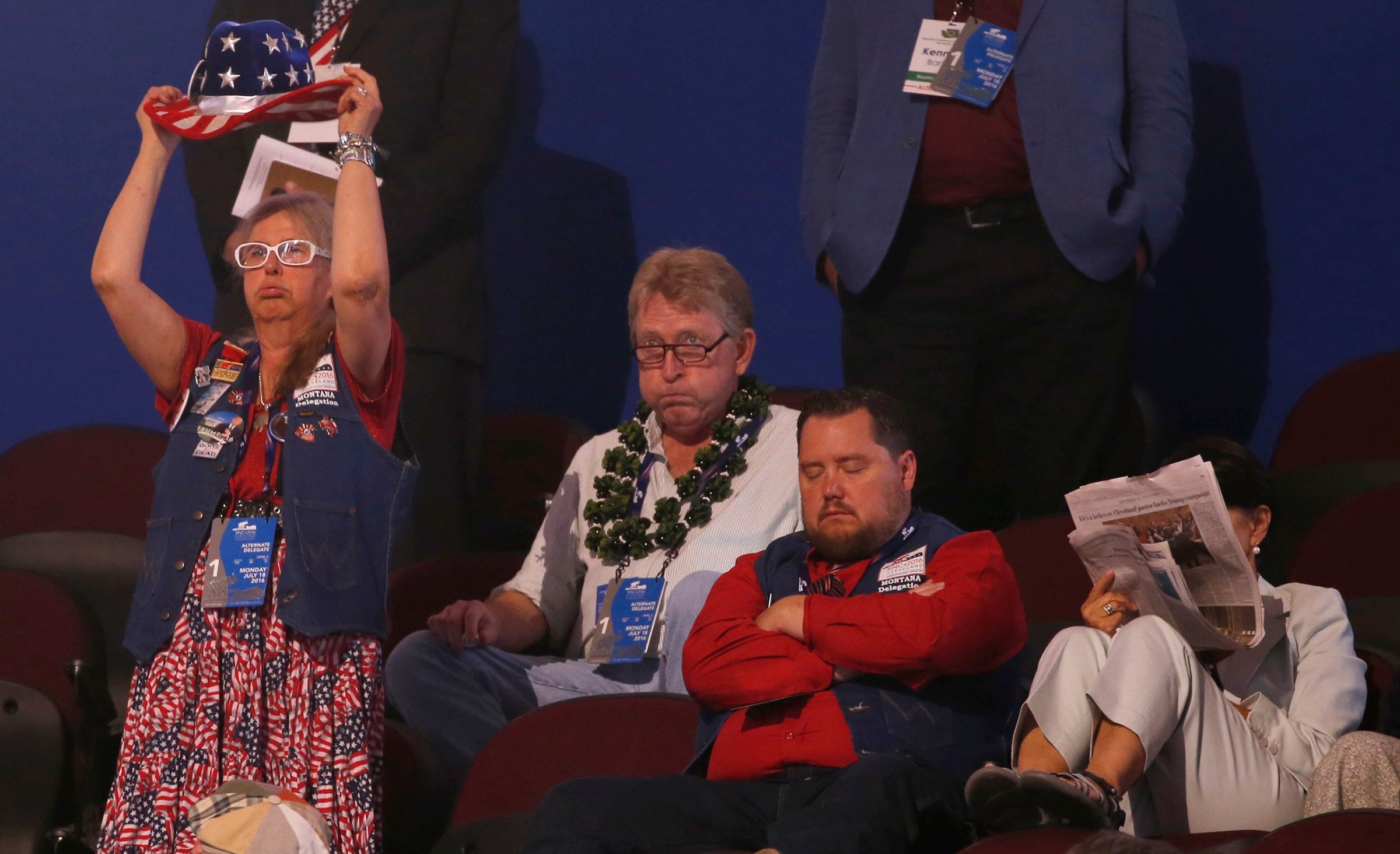 Alternate delegates and visitors watch with a variety of expression at the Republican National Convention in Cleveland, Ohio, on July 18, 2016.