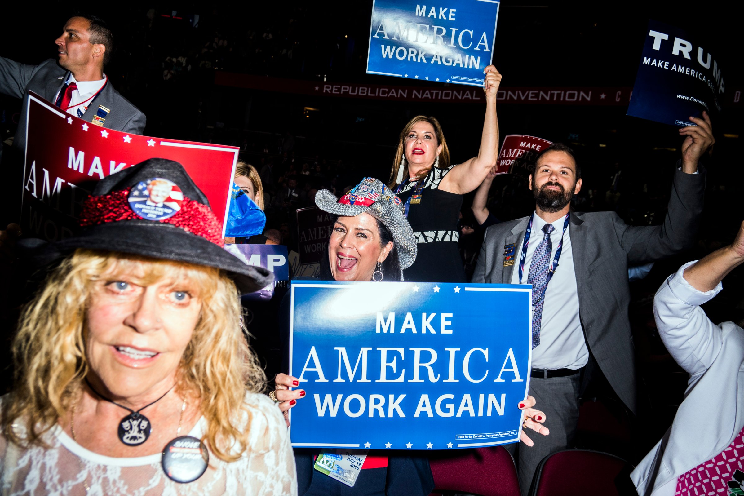 Attendees hold signs at the Republican National Convention in Cleveland on July 19, 2016