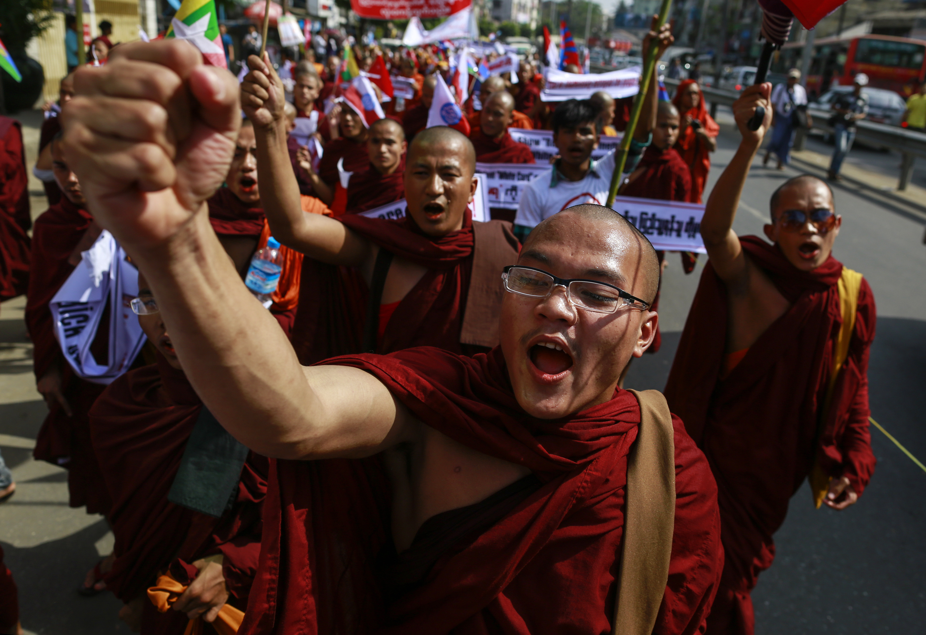 Buddhist monks and other people take part in a protest to demand the revocation of the right of holders of temporary identification cards, known as white cards, to vote, in Yangon