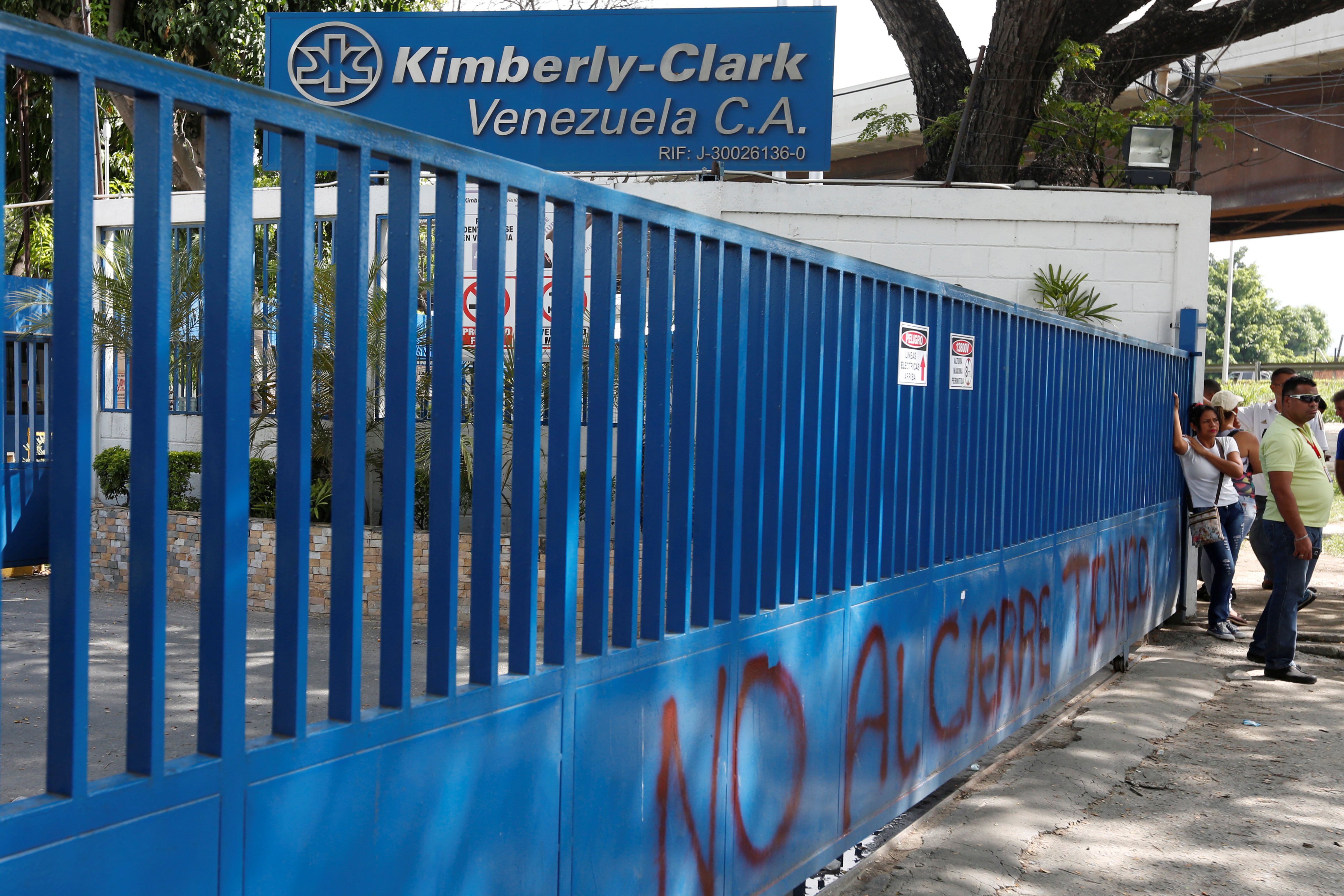Employees stand outside Kimberly-Clark in Maracay