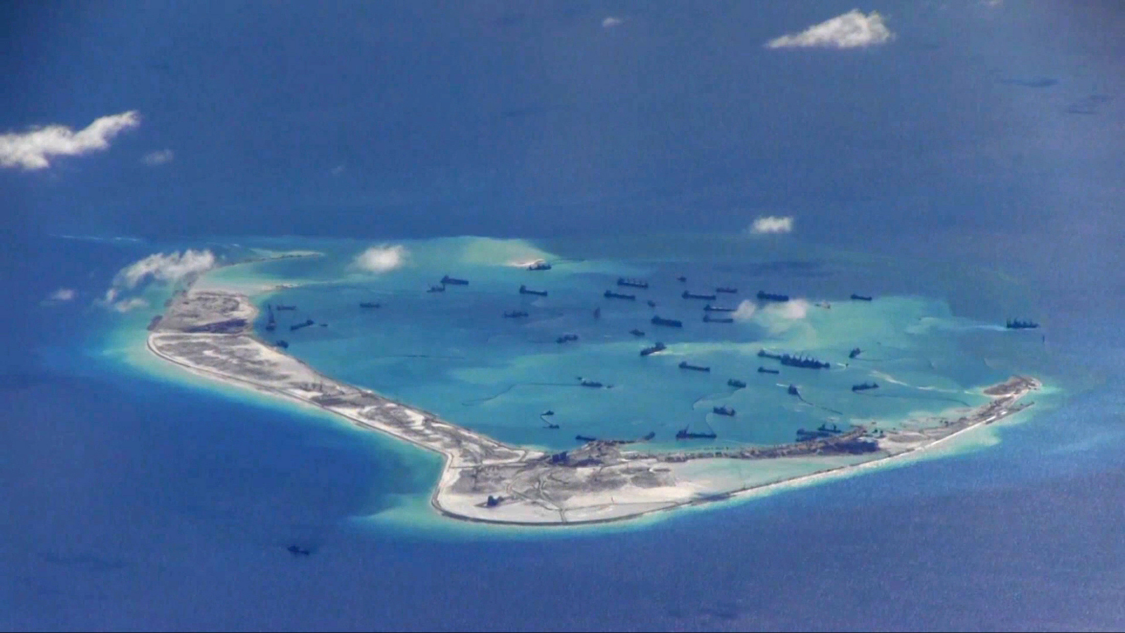 Chinese dredging vessels purportedly in the waters around Mischief Reef in the disputed Spratly Islands in the South China Sea in this still video image from a P-8A Poseidon surveillance aircraft provided by the U.S. Navy on May 21, 2015 (Handout/Reuters)