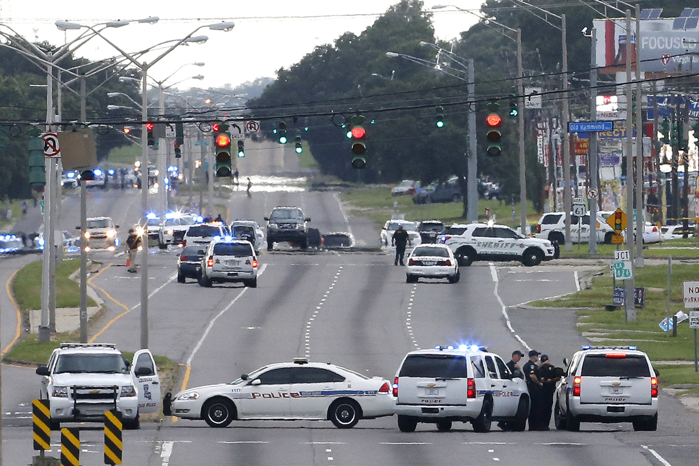 Law enforcement vehicles block access to Airline Highway near the scene of a fatal shooting of police officers in Baton Rouge
