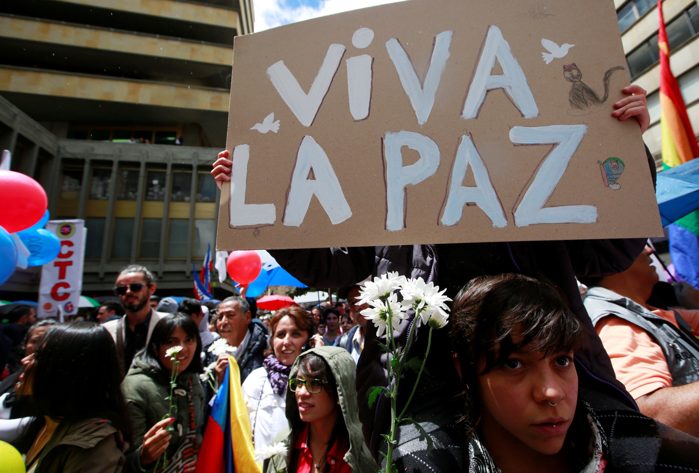 People celebrate the signing of a historic ceasefire deal between the Colombian government and FARC rebels in Bogota