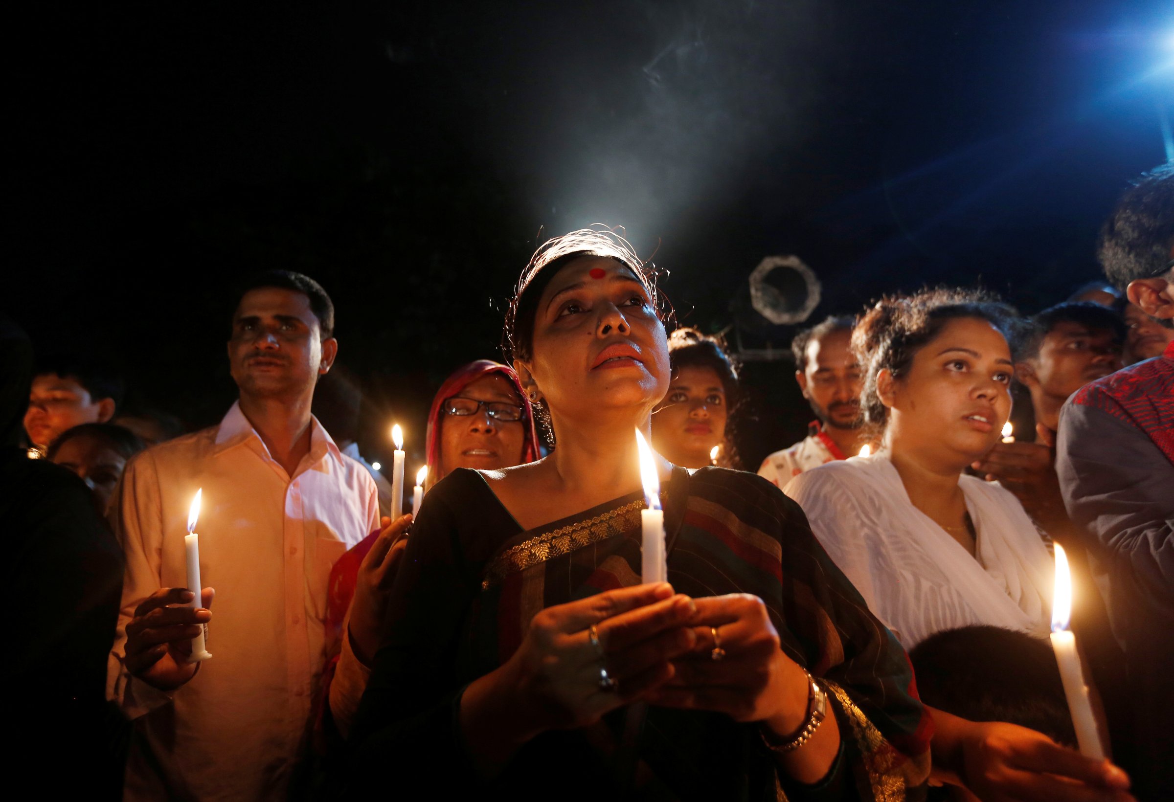 People attend a candle light vigil for the victims of the attack on the Holey Artisan Bakery and the O'Kitchen Restaurant, in Dhaka