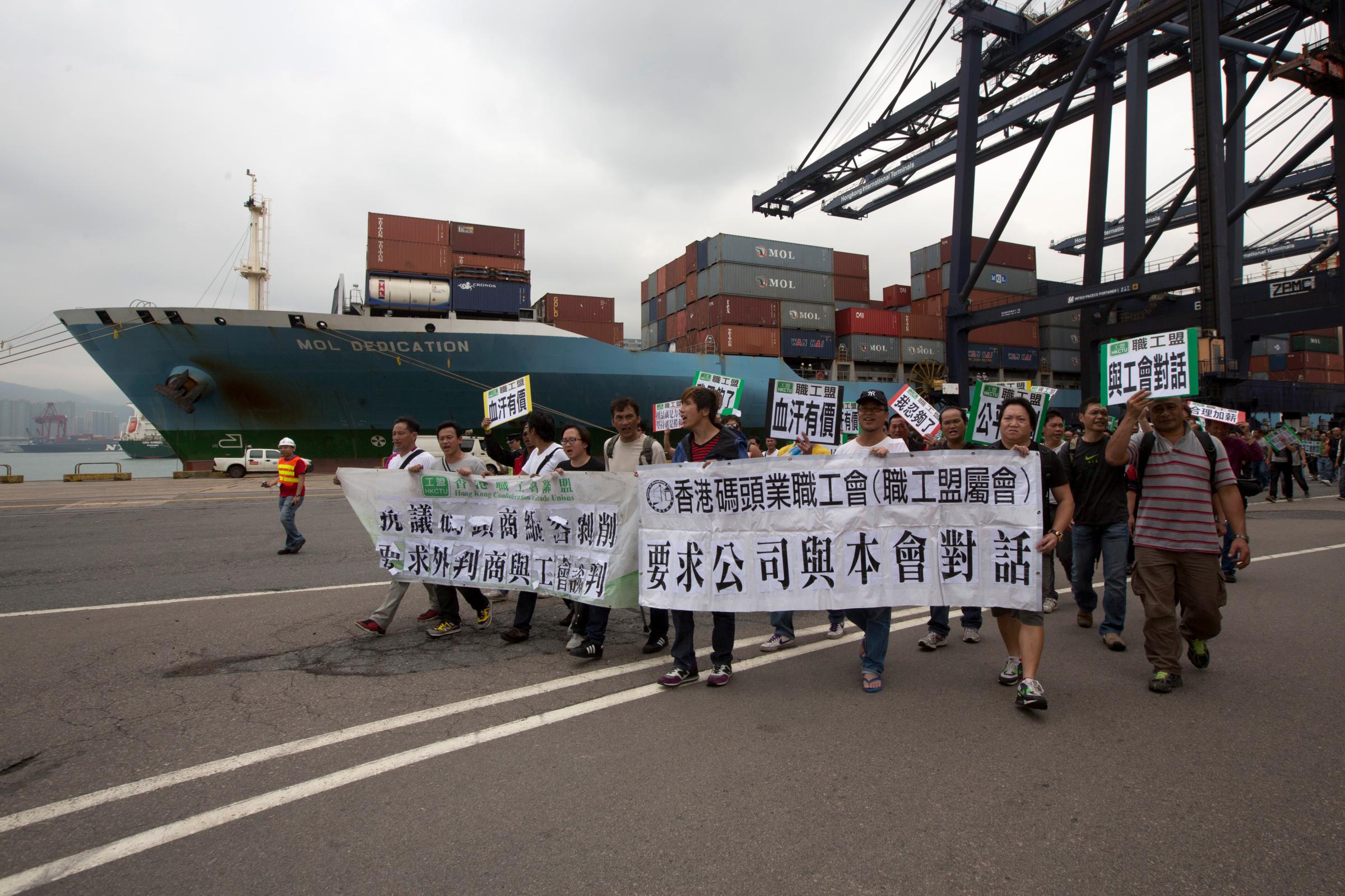 Dock workers march during a strike at Kwai Chung container terminal in Hong Kong