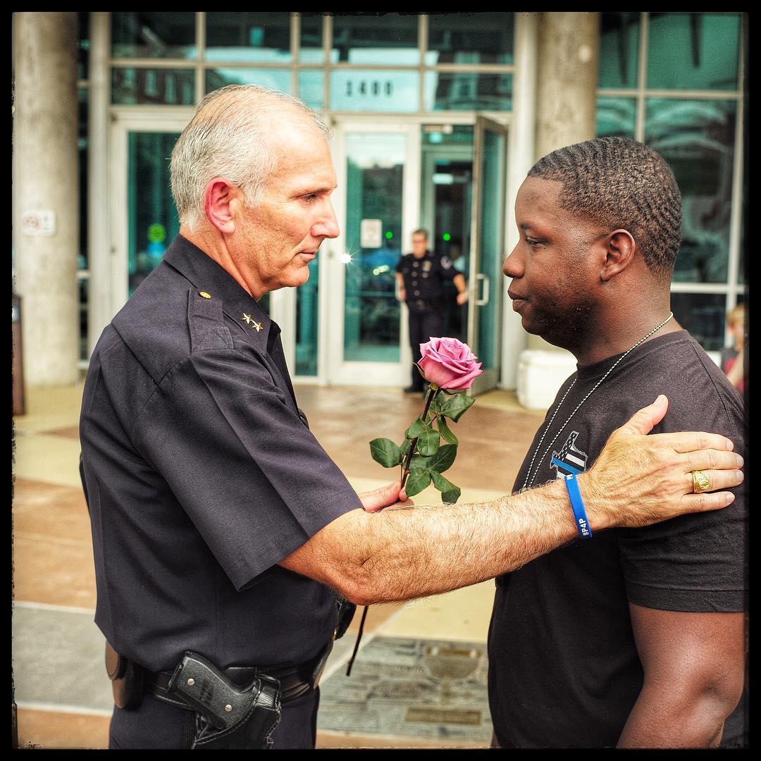 Assistant Chief of Police Gary Tittle comforts a young man in front of the police station where a memorial was erected for people to come and grieve. Dallas, Texas. (Ruddy Roye for TIME)