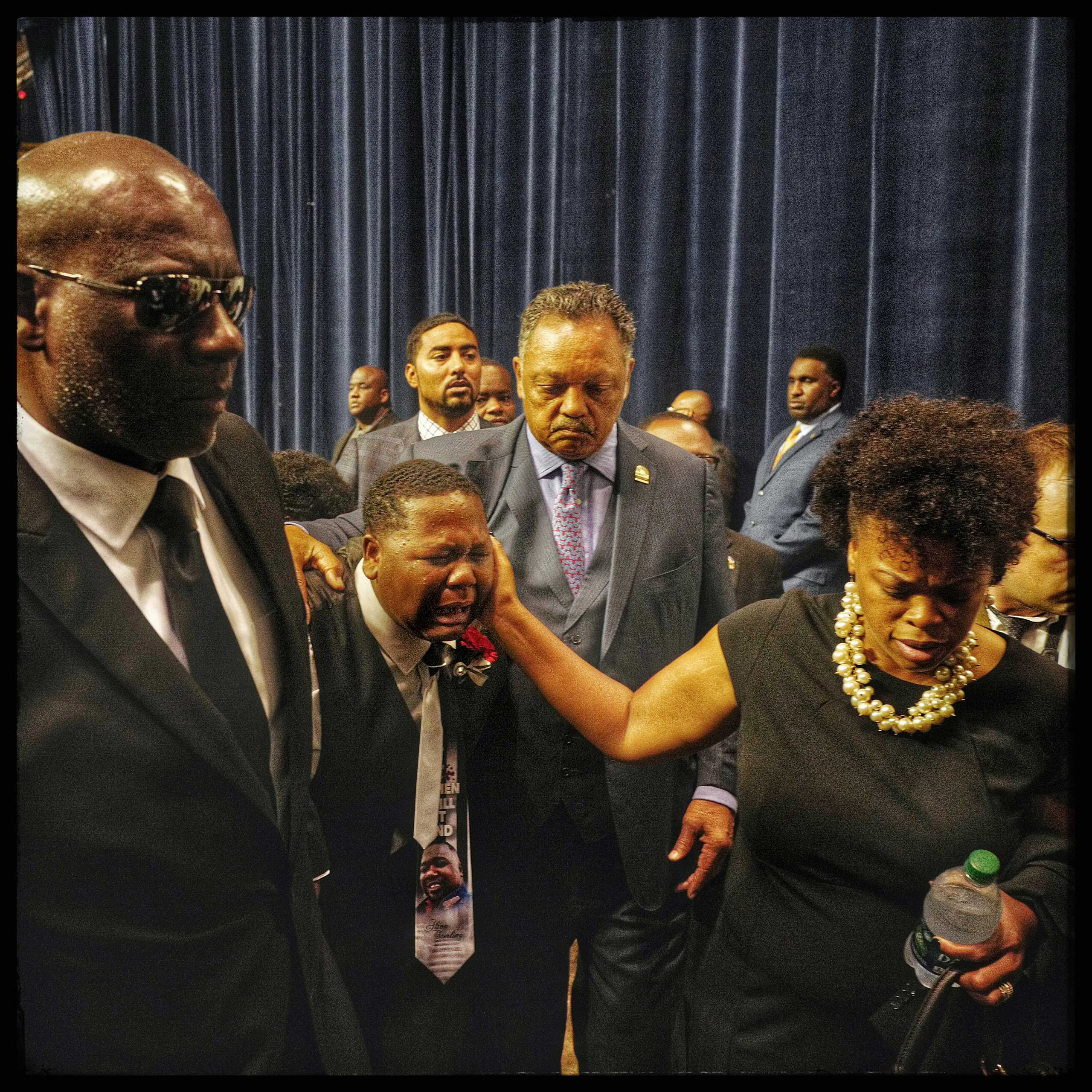 Baton Rouge, La: Fifteen-year-old Cameron Sterling succumbs to the pain as he is led
                              out of the funeral of his father, Alton Sterling, accompanied by the Rev.
                              Jesse Jackson Sr. The funeral was held at the Southern University A&amp;M
                              College on July 15, 2016.