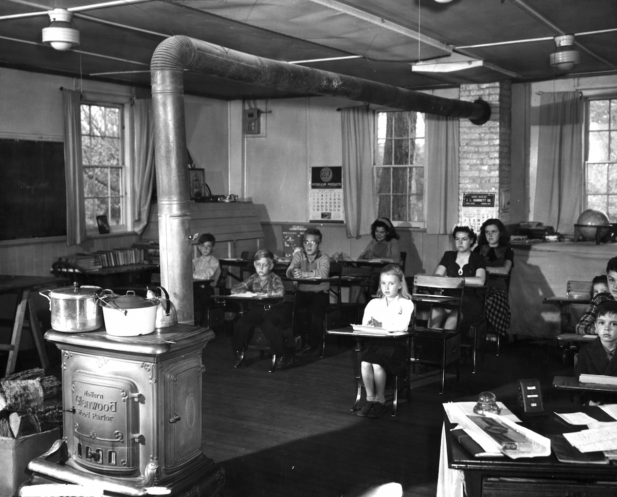 Student sit in a one-room Churchill school where a stove both heats the room and cooks lunch, Brockfield, N.H., 1947. (PhotoQuest / Getty Images)