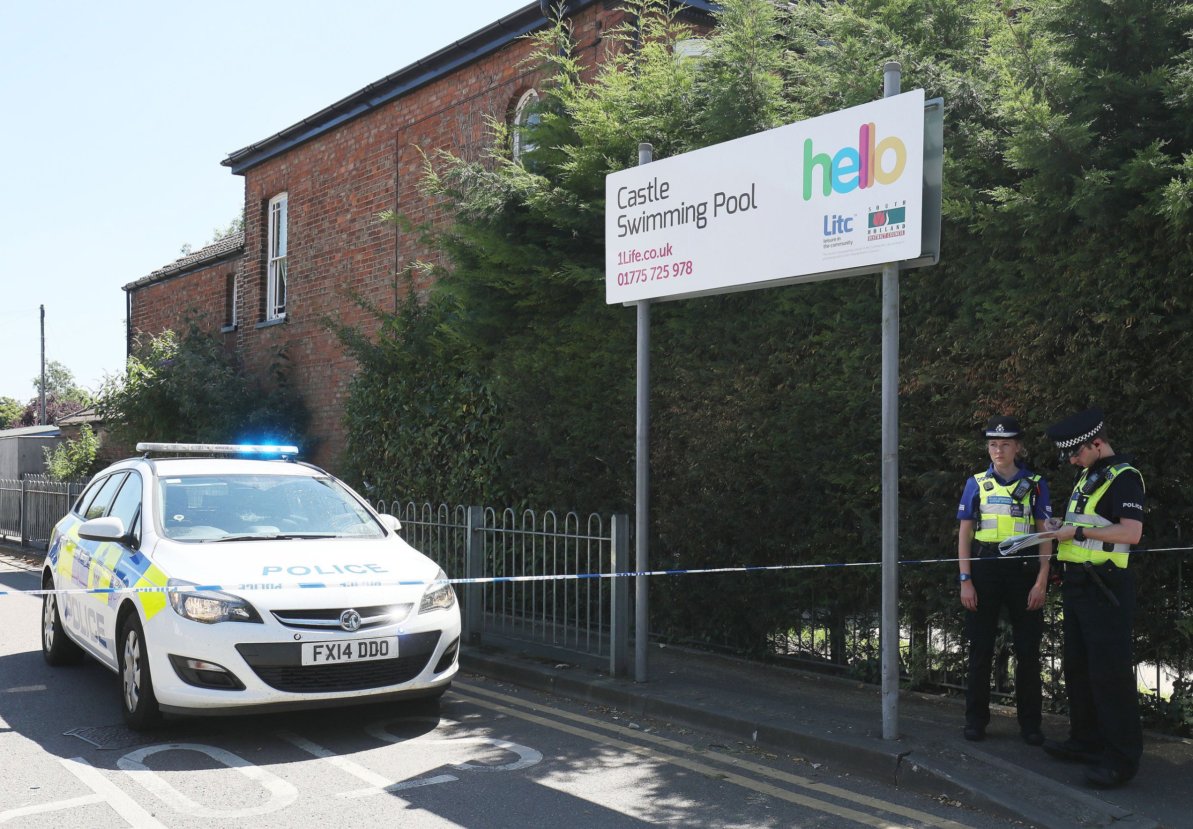 Emergency services at the scene near Castle Swimming Pool after three people including a suspected gunman have been shot dead in Spalding, Lincolnshire on July 19, 2016.