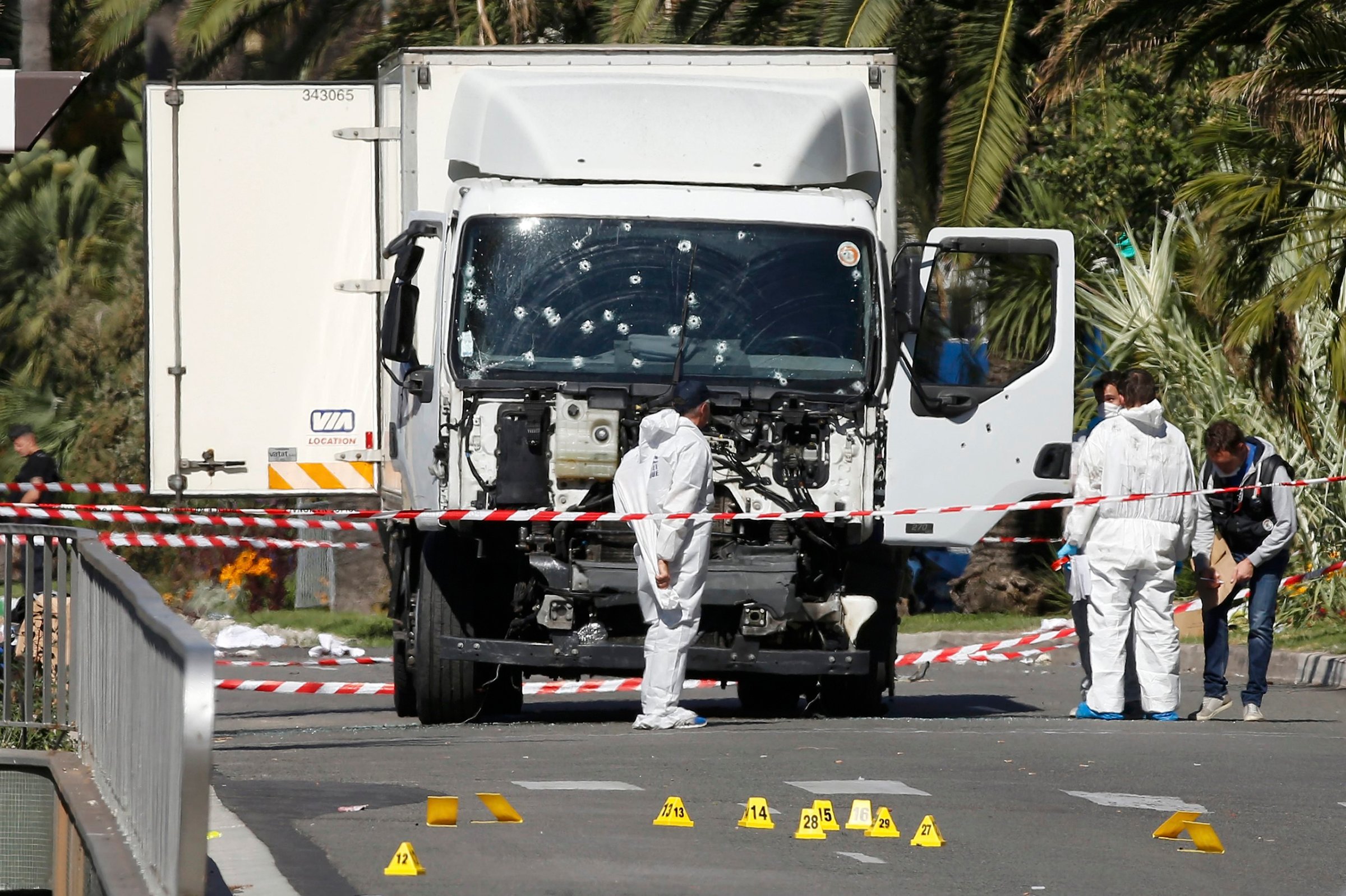 Investigators continue to work at the scene near the truck that was driven into a crowd at high speed, killing scores who were celebrating Bastille Day on July 14, on the Promenade des Anglais in Nice, France, on July 15, 2016.