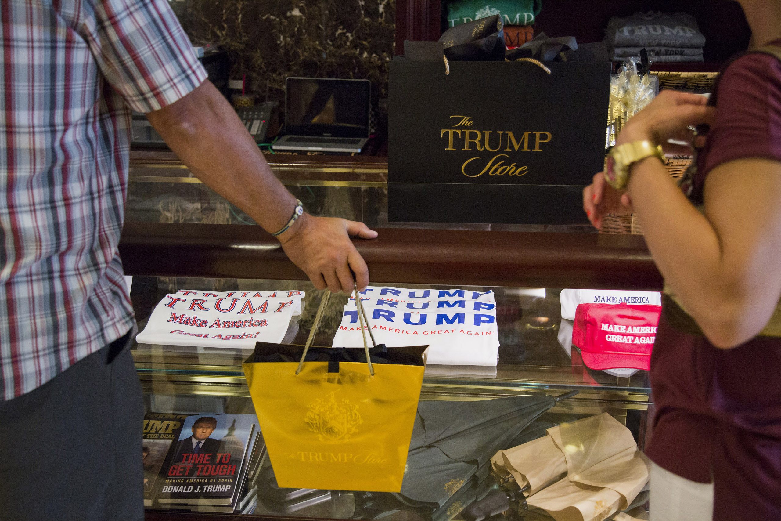 Shoppers purchase merchandise supporting Donald Trump, president and chief executive of Trump Organization Inc. and 2016 Republican presidential candidate, inside a store at Trump Tower in New York City on Aug. 26, 2015. (Bloomberg/Getty Images)