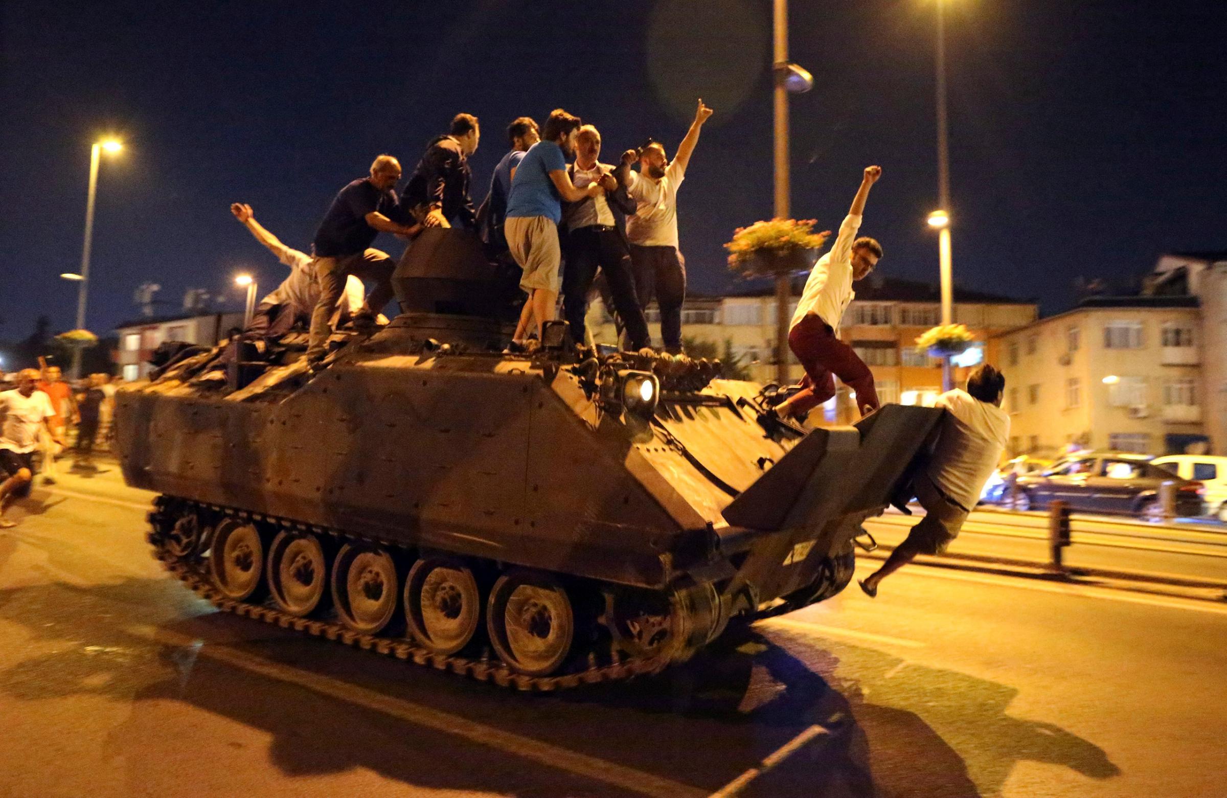 People occupy a tank in Istanbul, Turkey, on July 16, 2016. Turkish Prime Minister Yildirim reportedly said that the Turkish military was involved in an attempted coup d'etat. The Turkish military meanwhile stated it had taken over control.