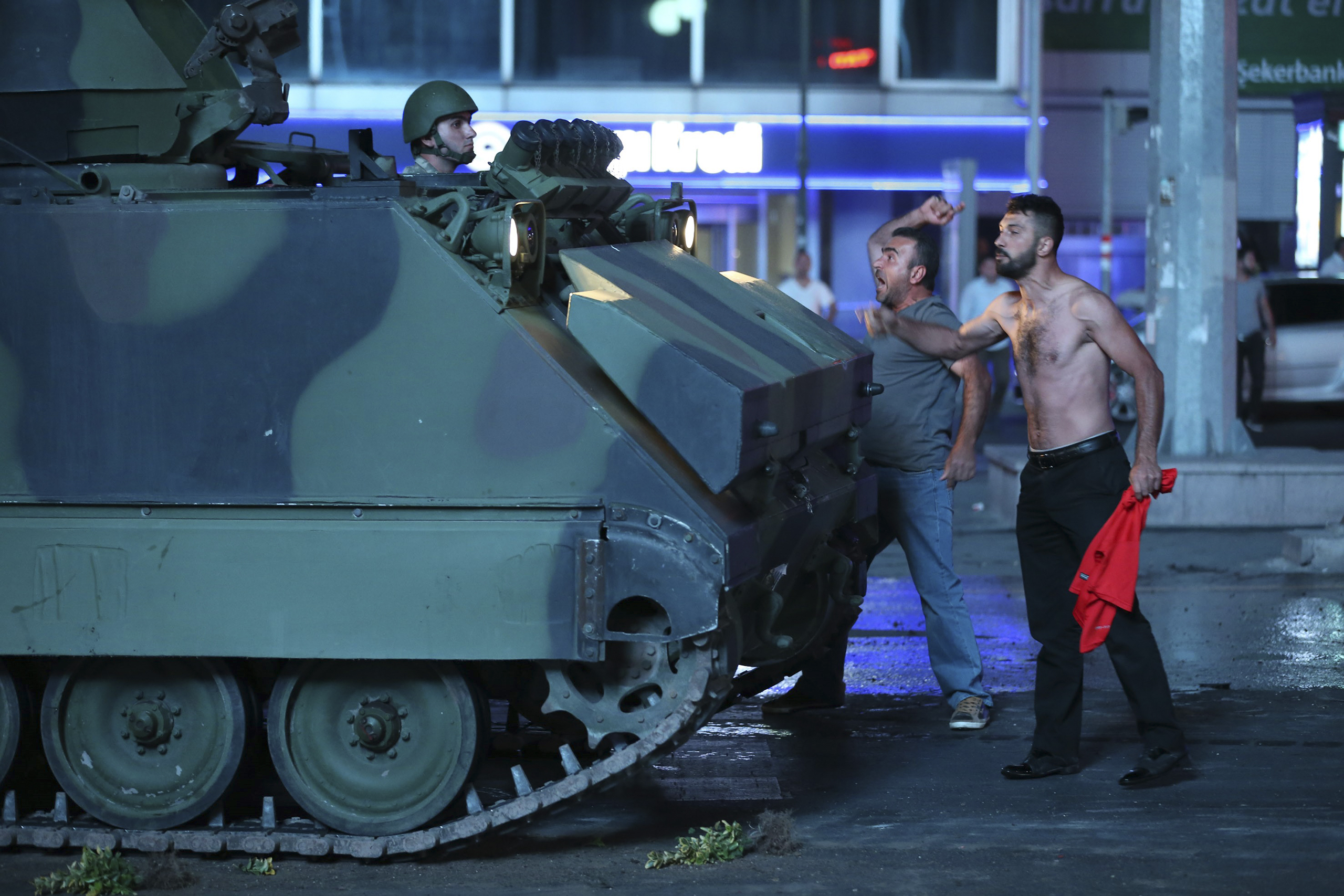 Two men react against a coup attempt from within the army in Ankara, Turkey, on July 16, 2016.