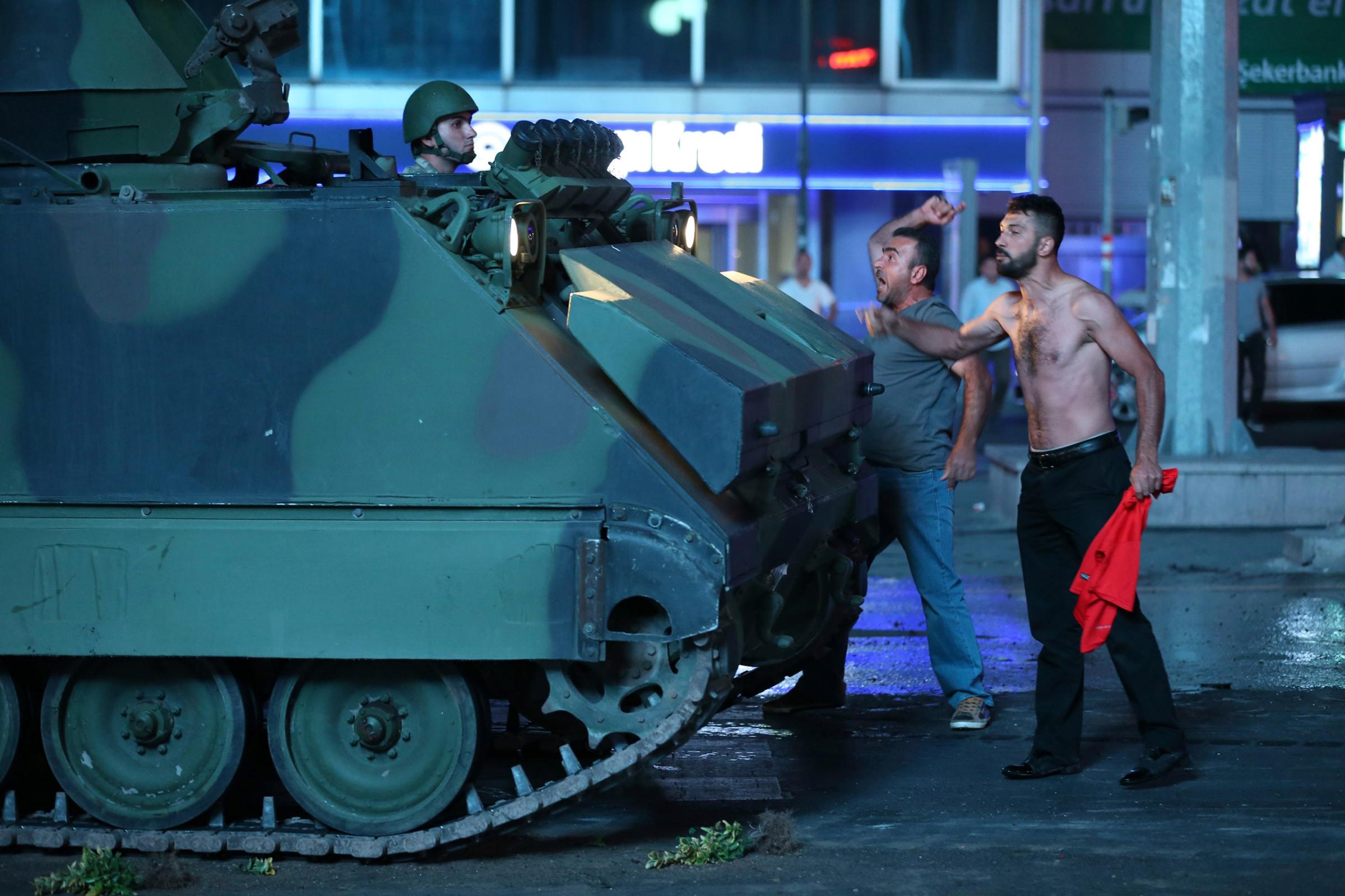 Two men react against a coup attempt from within the army in Ankara, Turkey, on July 16, 2016.