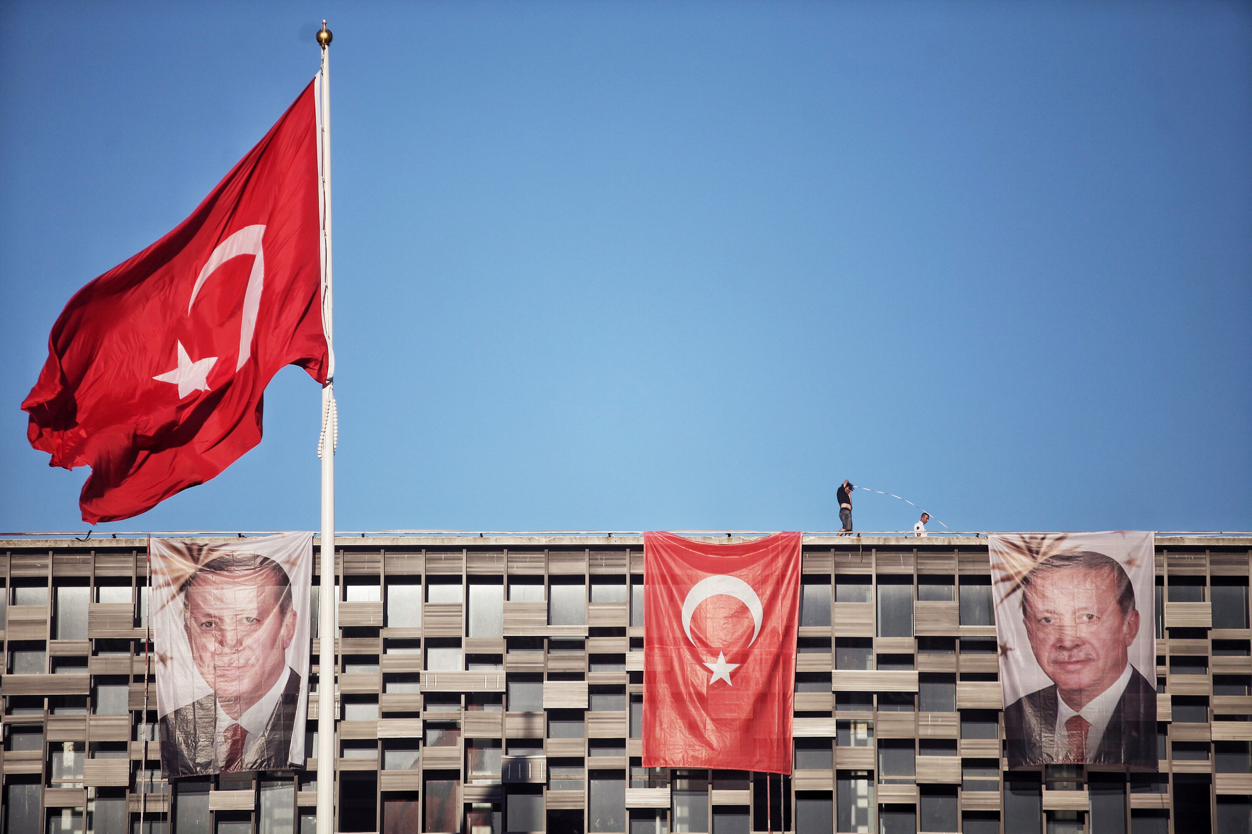 Posters of Turkey's President Recep Tayyip Erdogan and a Turkish flag hangs on Ataturk Cultural Center at Istanbul's central Taksim on July 19, 2016. (Kursat Bayhan—Getty Images)