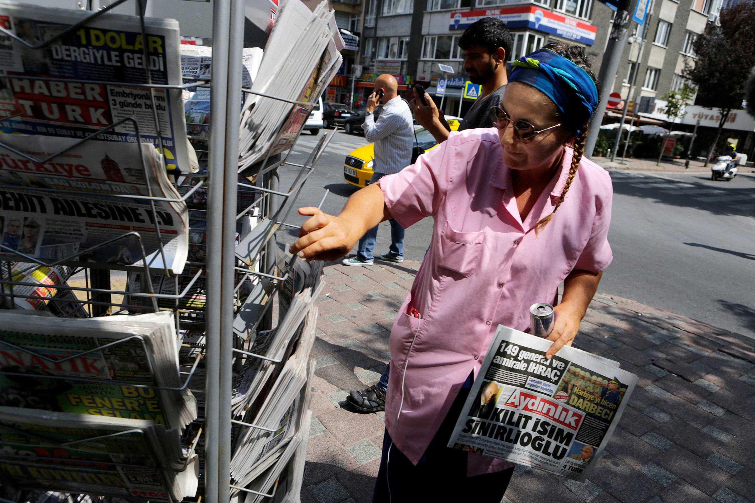 A woman buys a newspaper from a kiosk in Istanbul on July 28, 2016.