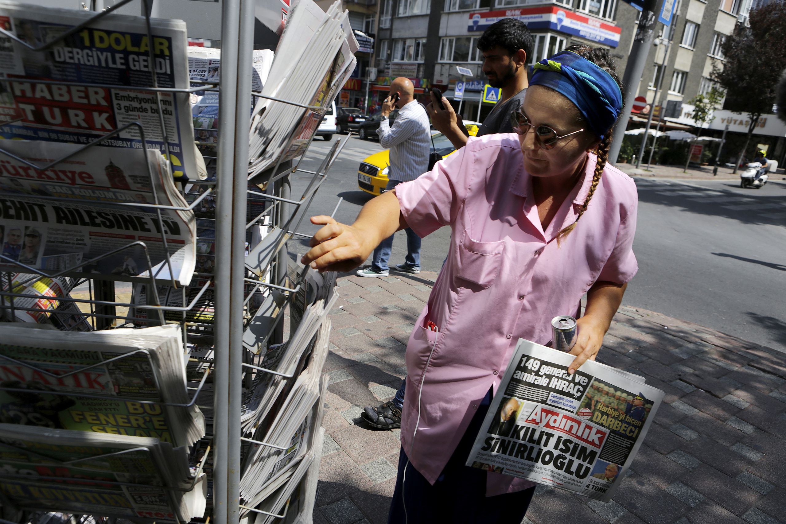 A woman buys a newspaper from a kiosk in Istanbul on July 28, 2016. (Petros Karadjias—AP)