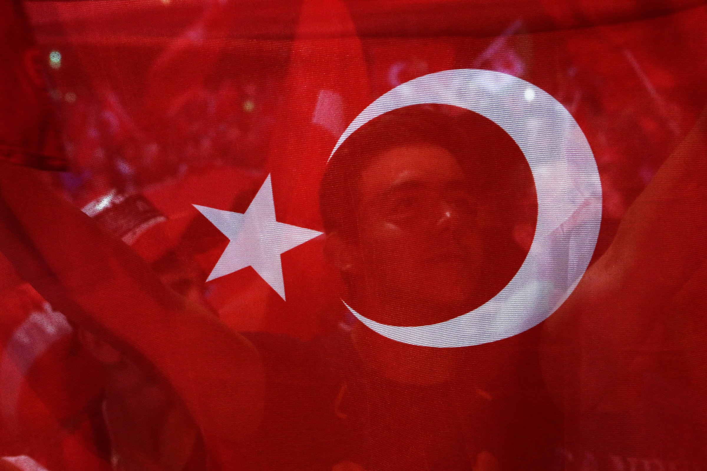 A man holds a Turkish flag during an anti coup rally at Taksim square in Istanbul, on July 26, 2016.