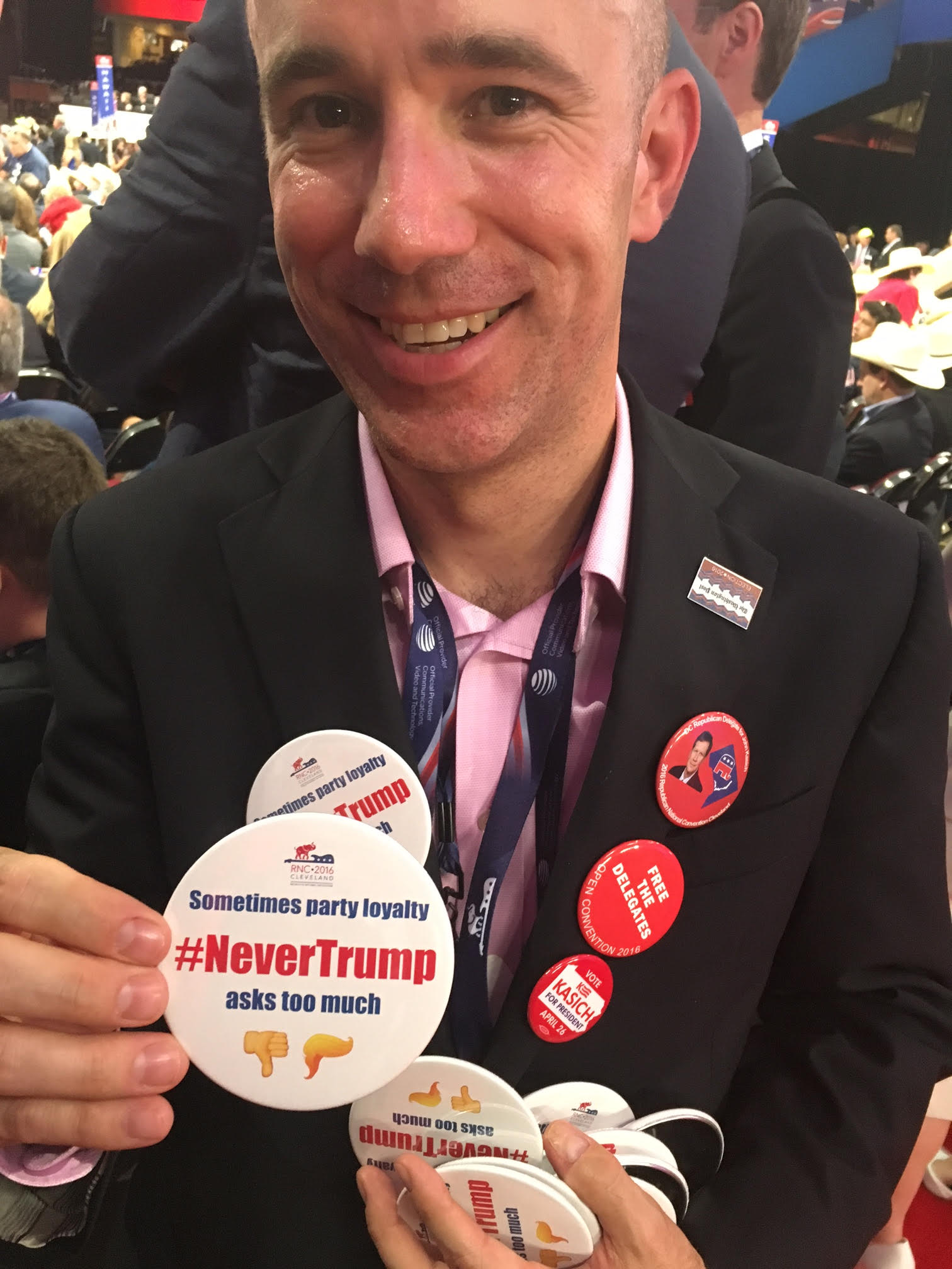 Justin Dillon, an alternate delegate from the District of Columbia is handing out 200 buttons opposing Donald Trump on the convention floor, in Cleveland, on July 21, 2016. (Zeke Miller for TIME)