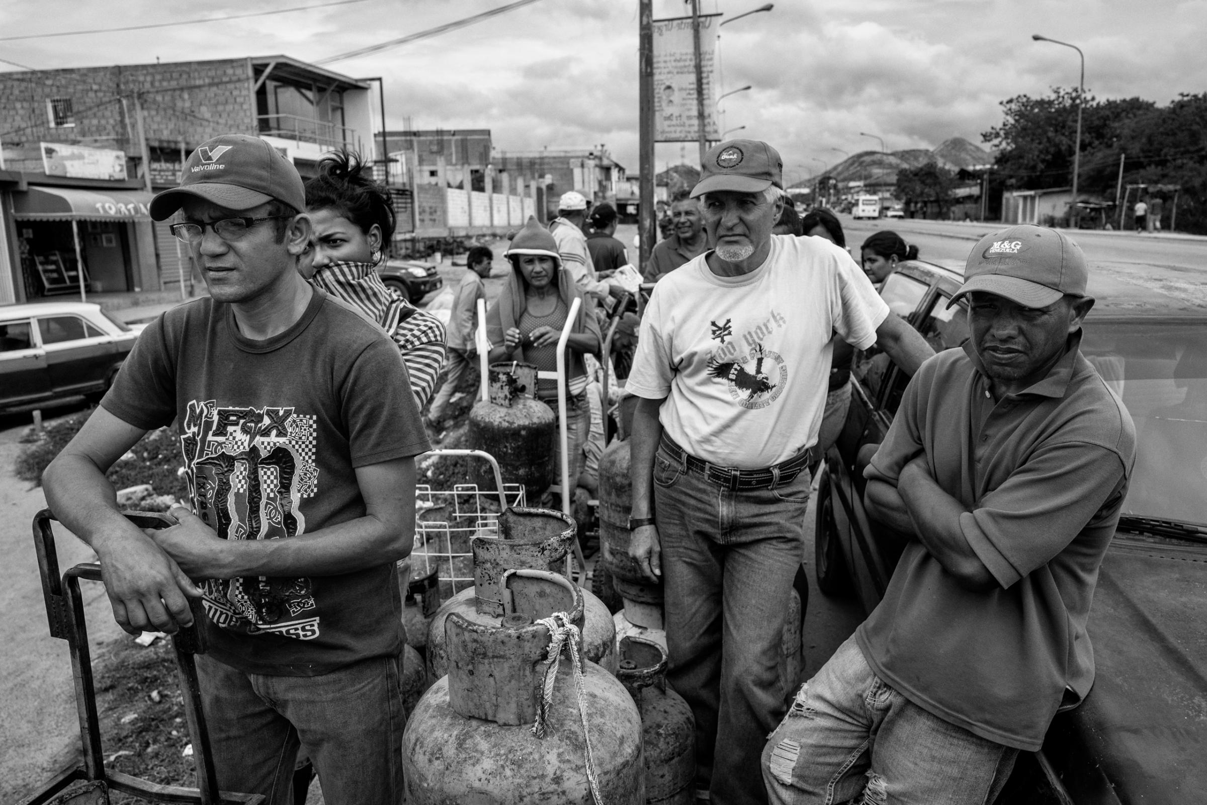People line up for gas, which is needed for cooking and hot water. Because of severe shortages in the country, tension and discontent among the civilian population has grown resulting in outbreaks of violence and looting throughout the country, Barquisimeto, Venezuela, June 2016. BARQUISIMETO, VENEZUELA - JUNE 2016: A group of civilians queuing to get gas. Shortages in Venezuela is total. The government controls access to commodities. The tension and discontent among the civilian population is increasing and outbreaks of violence and looting are repeated throughout the country. ( Photo by Alvaro Ybarra Zavala / Getty Images Reportage for Time.)