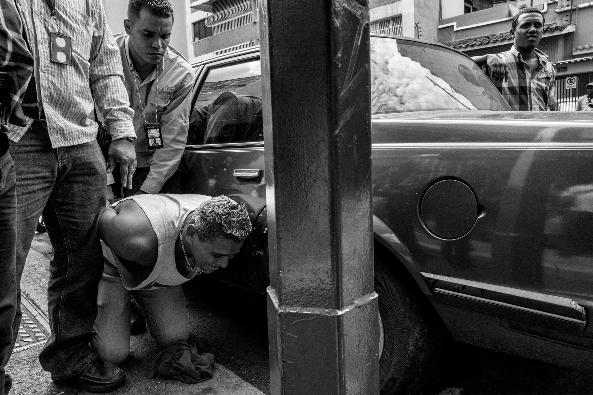 An alleged thief is arrested by police in Caracas, Venezuela. The economic and political crisis in Venezuela has led to increased crime and abuses by police, May 2016.
