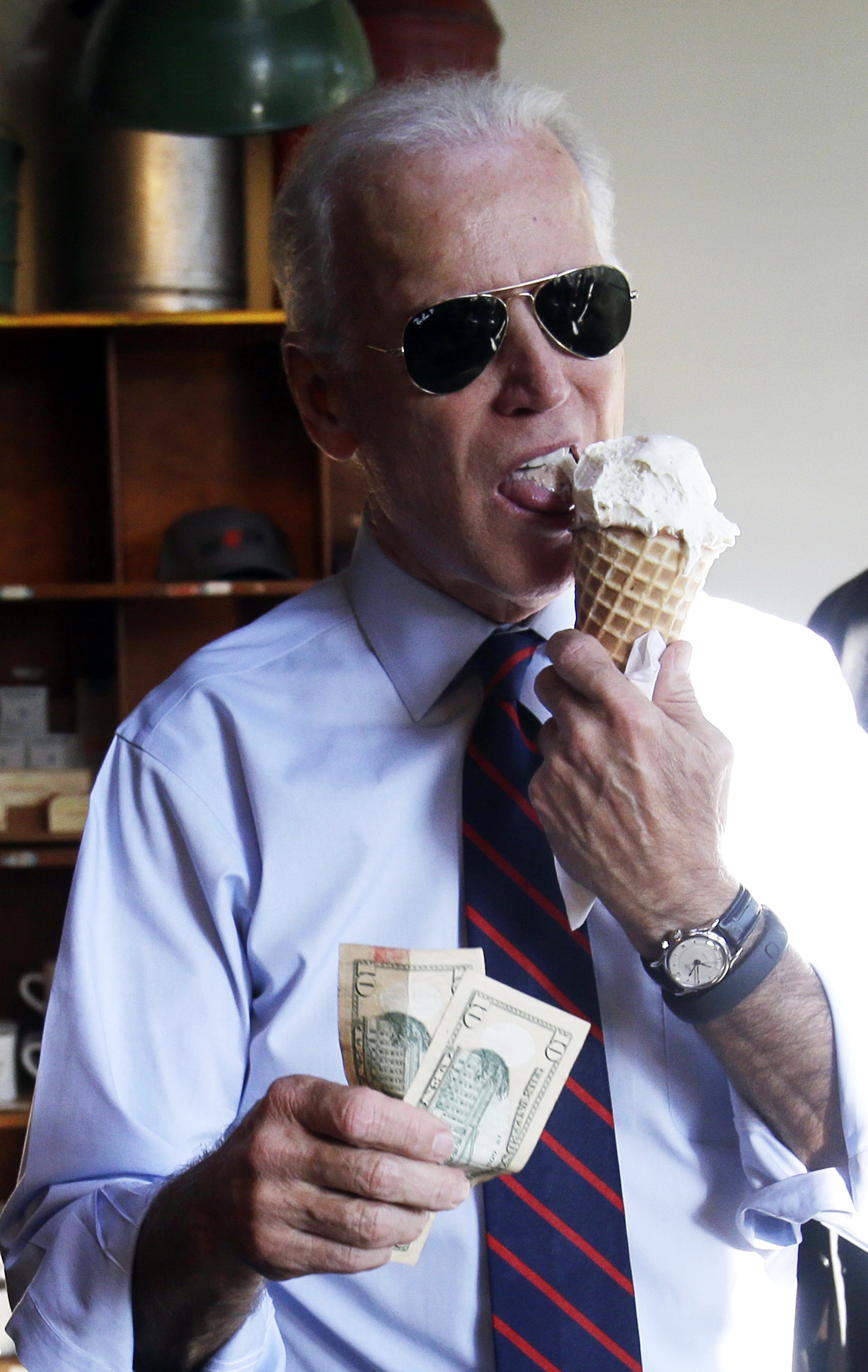 Vice President Joe Biden gets ready to pay for an ice cream cone after a campaign rally for U.S. Sen.  Jeff Merkley in Portland, Ore. on Oct. 8, 2014.