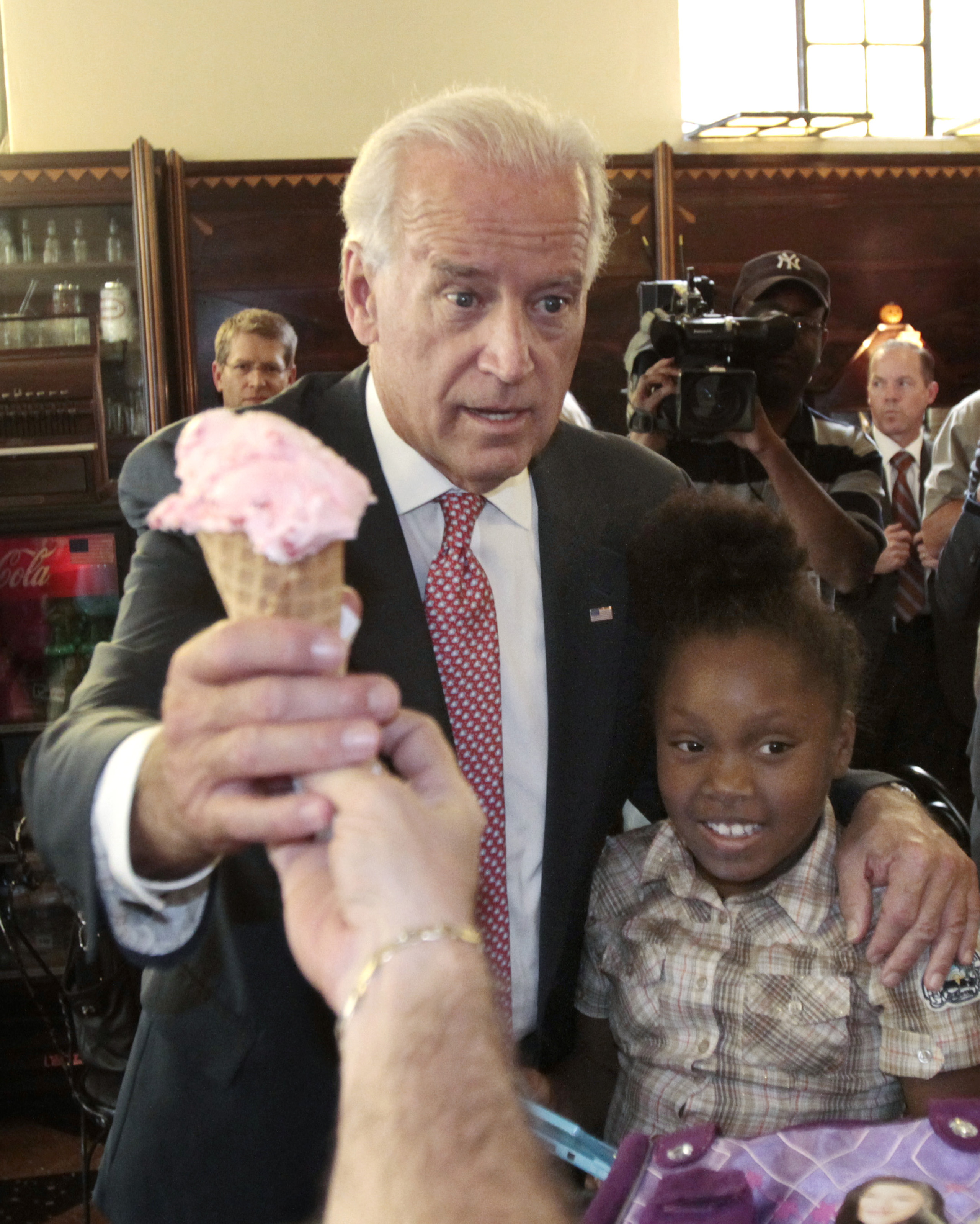 Joe Biden gets a  Whitehouse Cherry  flavored ice-cream cone with his arm around 9-year Dizney Stephens during a visit to Klavon's Authentic 1920's ice cream parlor in Pittsburgh, on Oct. 11, 2010.