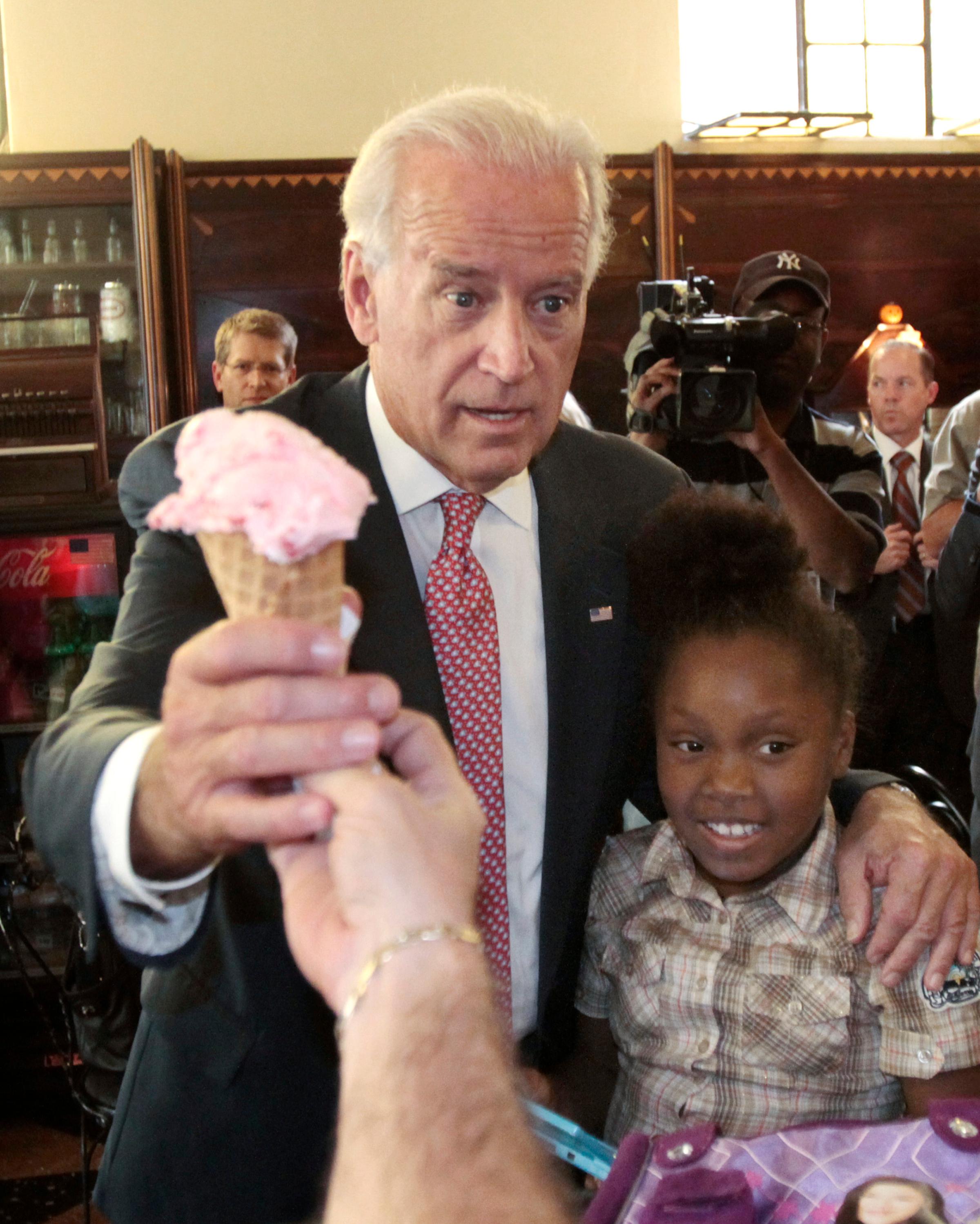 Joe Biden gets a "Whitehouse Cherry" flavored ice-cream cone with his arm around 9-year Dizney Stephens during a visit to Klavon's Authentic 1920's ice cream parlor in Pittsburgh, on Oct. 11, 2010.