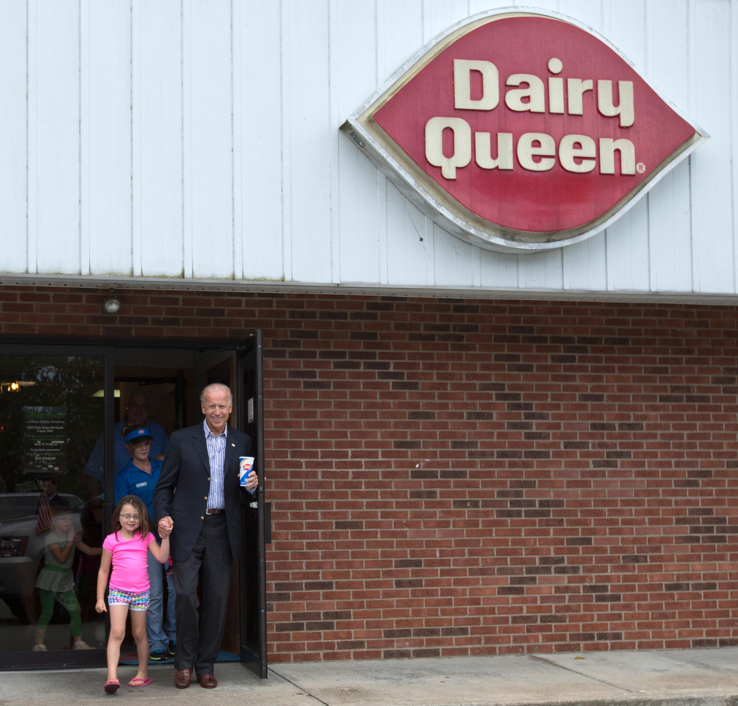 Joe Biden leaves Dairy Queen with an ice cream cone, holding the hand of a little girl, in Nelsonville, Ohio, on Sept. 8, 2012.