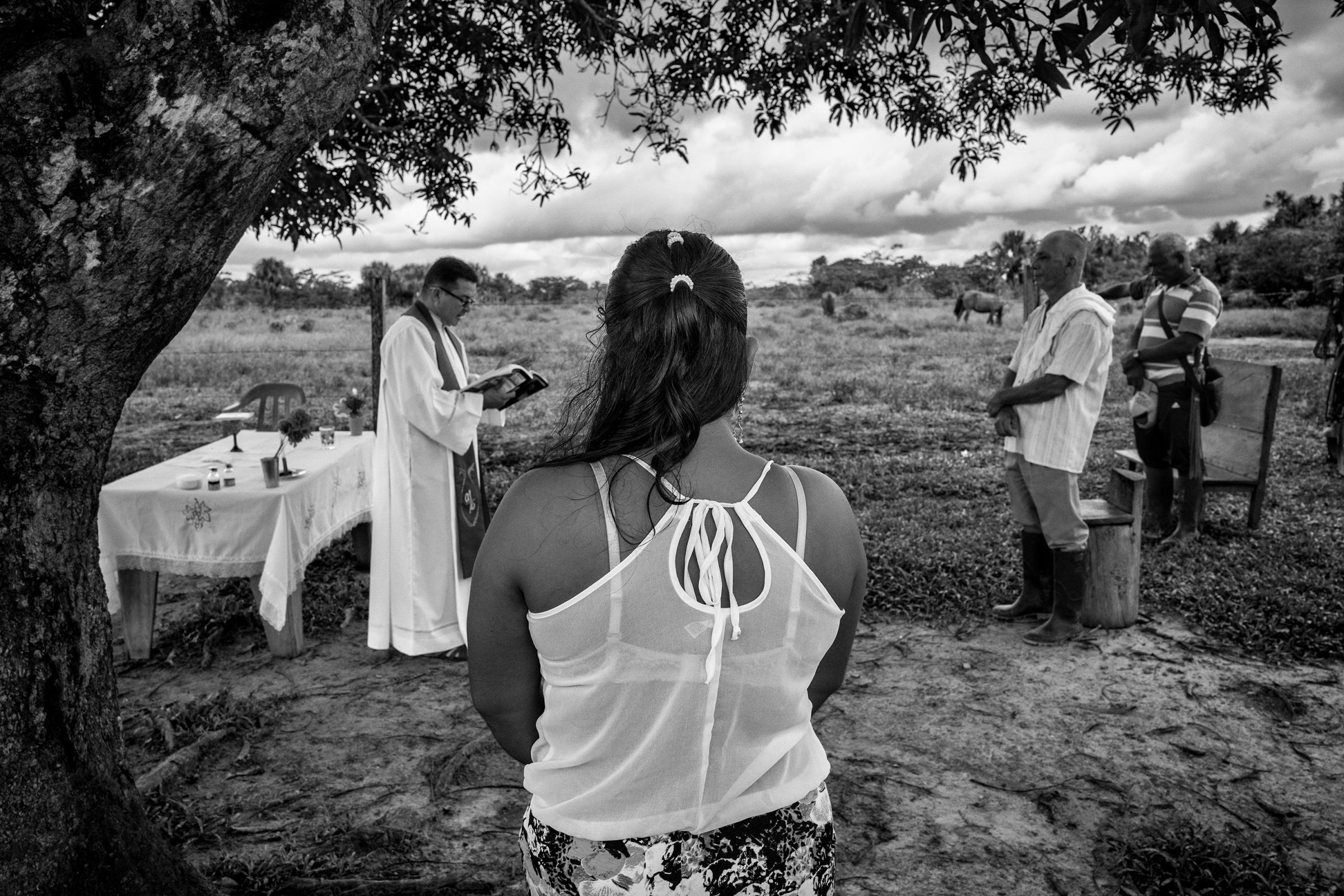 A group of civilians attend a Catholic Mass in the community of Puerto Camelias del Caguan. Both religion and FARC play central roles in communities where FARC has been the only authority for over 50 years, Aug. 24, 2016
