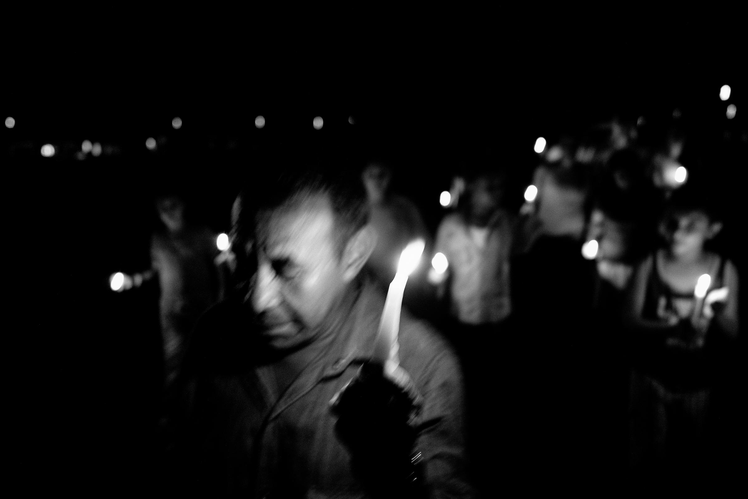 Holding candles, members of the community from Re- moiinos del Caguan attend a vigil for peace. Since the unilateral ceasefire announcement of the FARC, there are signs of the re-emergence of paramilitary units in the region, Caqueta, Colombia, April 2016.