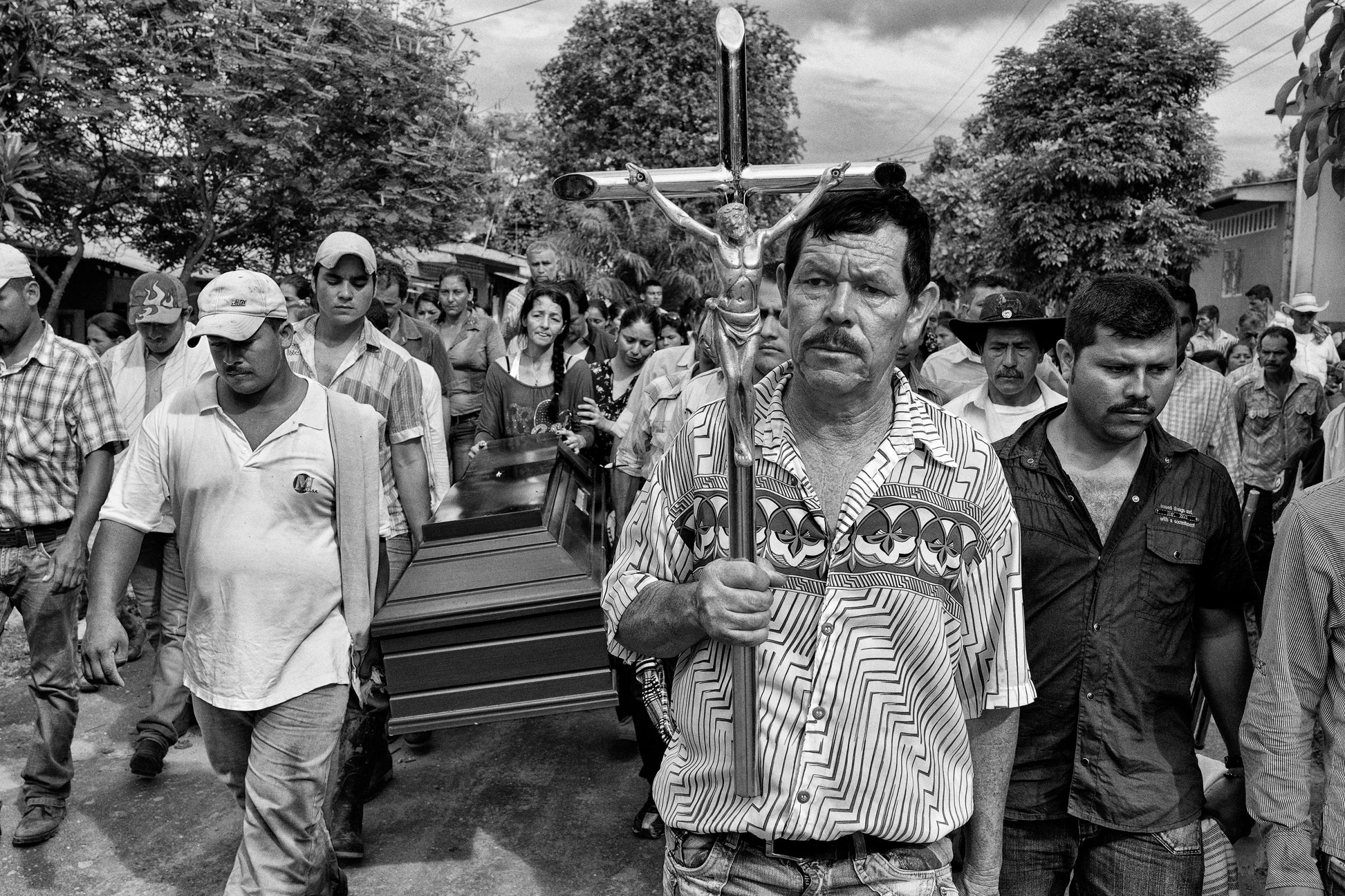 Relatives and friends carry the body of 18-year old Benjamin to the cemetery for burial, Nov. 2013, La Union Peneya, Caqueta, Colombia, Nov. 2013. Benjamin died at age 18 during a fight with the FARC guerrillas