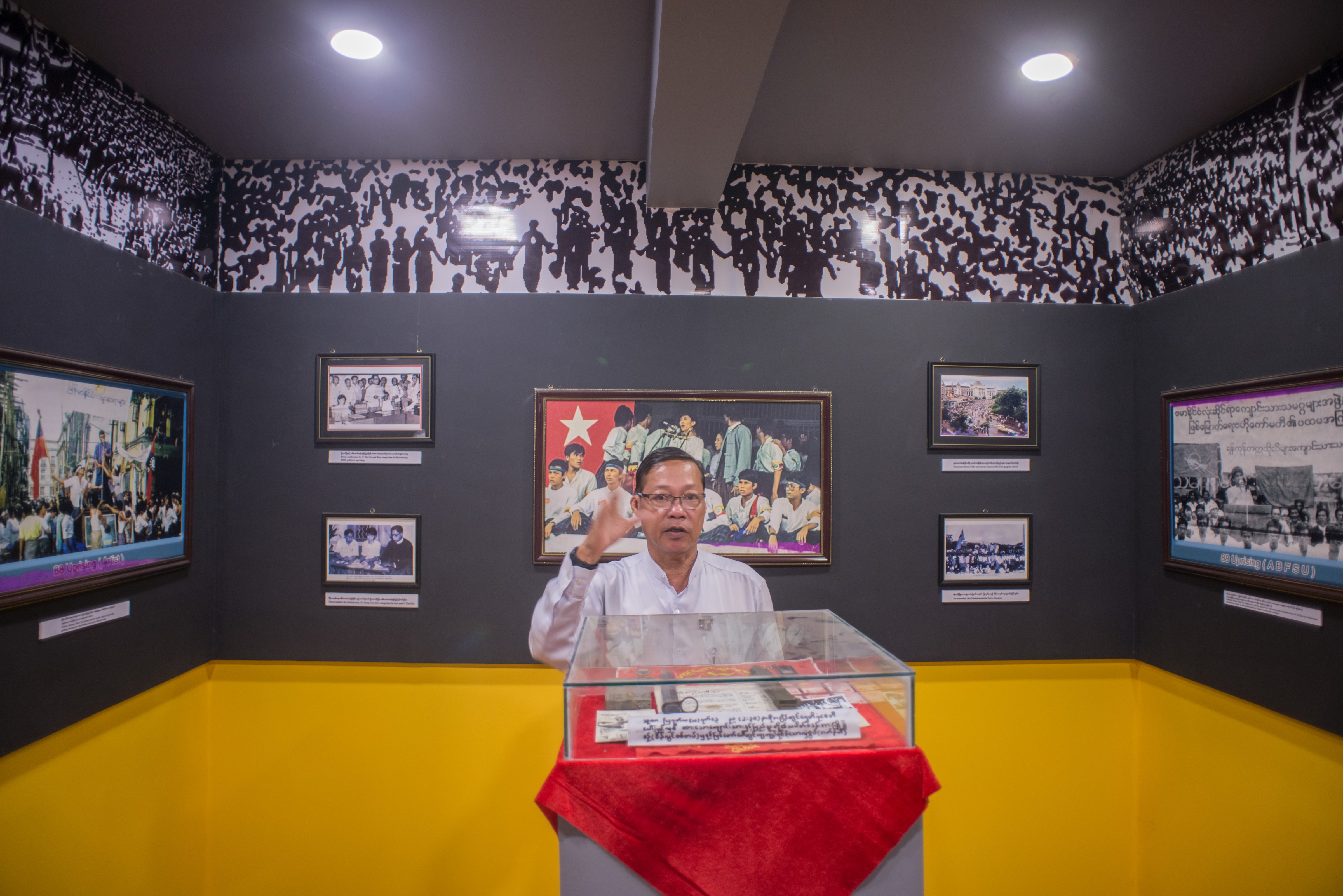 Former student activist Aung Maw speaks to visitors at the 88 Memorial Hall in Rangoon, Burma, on June 3, 2016 (Aung Naing Soe)