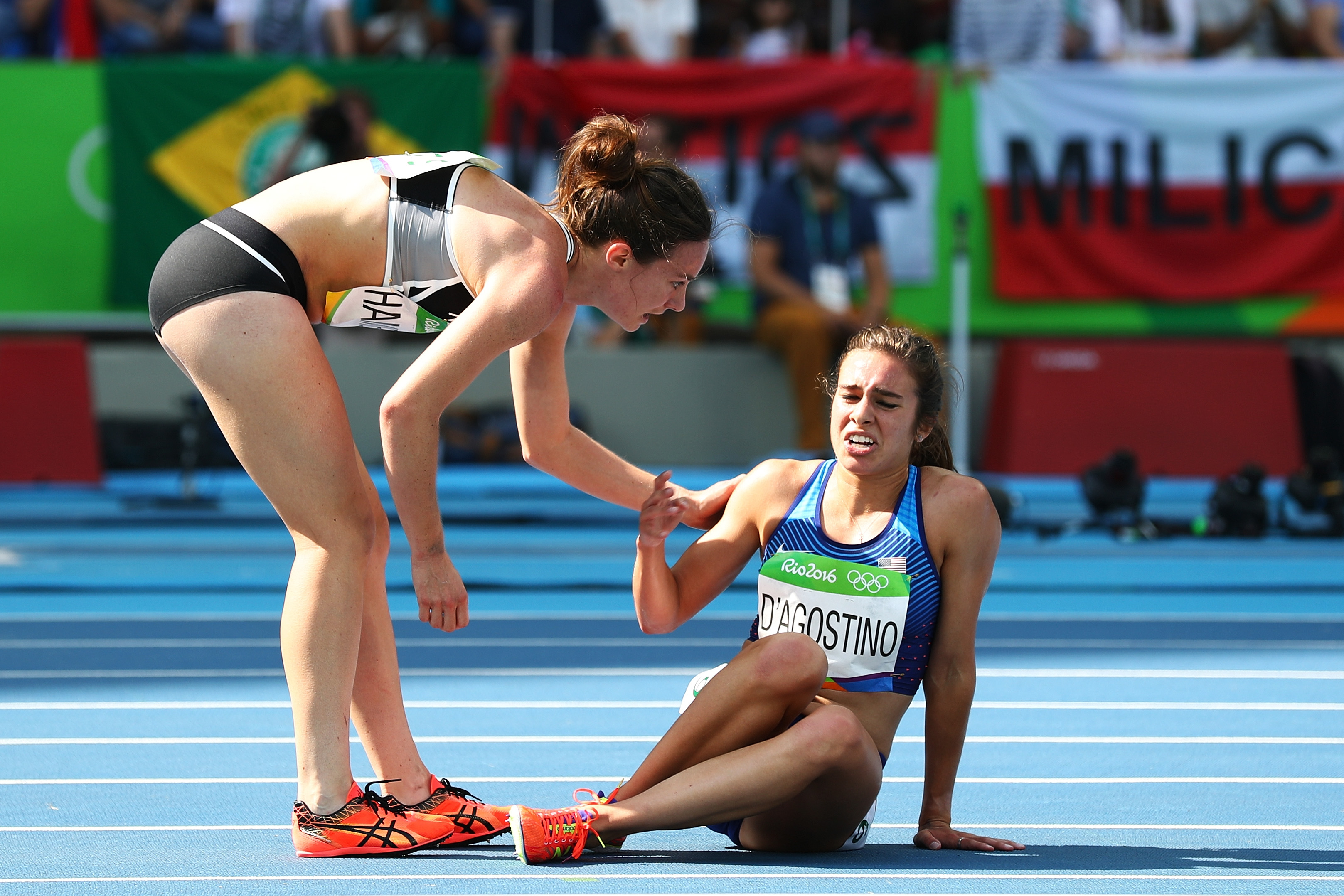 Abbey D'Agostino of the United States (R) is assisted by Nikki Hamblin of New Zealand after a collision during the Women's 5000m Round 1 - Heat 2 on Day 11 of the Rio 2016 Olympic Games at the Olympic Stadium on August 16, 2016 in Rio de Janeiro, Brazil. (Ian Walton—Getty Images)