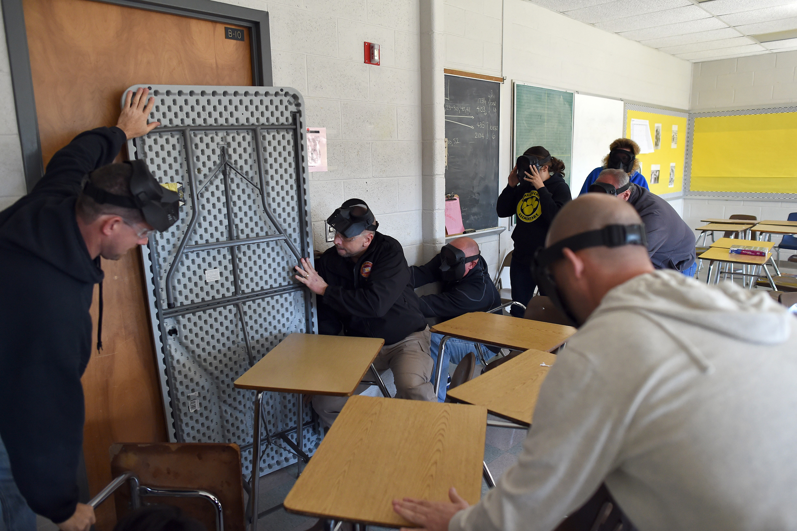 Participants barricade a door of a classroom to block an "active shooter" during ALICE (Alert, Lockdown, Inform, Counter and Evacuate) training at the Harry S. Truman High School in Levittown, Pennsylvania, on Nov. 3, 2015. (Jewel Samad—AFP/Getty Images)