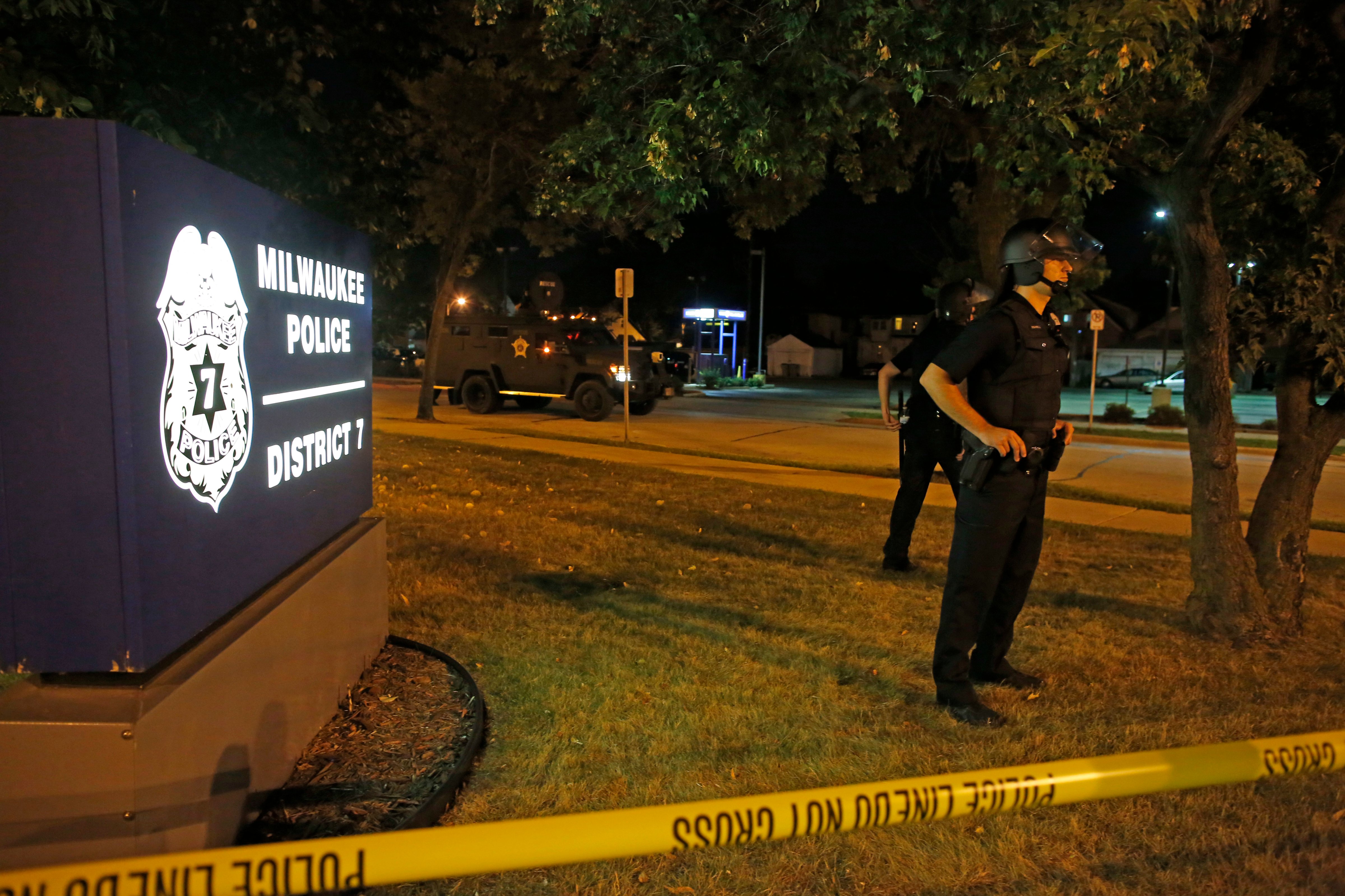 Police guard a police station in Milwaukee Aug. 14, 2016. Police said one person was shot at a Milwaukee protest on Sunday evening and officers used an armored vehicle to retrieve the injured victim during a second night of unrest over the police shooting of 23-year-old Sylville Smith. (Jeffrey Phelps—AP)