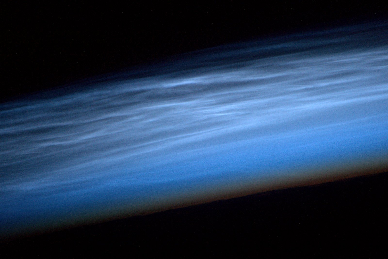 Noctilucent clouds, formed by ice crystals, high up in Earth's mesosphere.