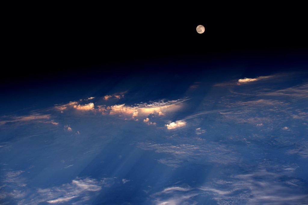 The full moon rises just before sunset, over western China.