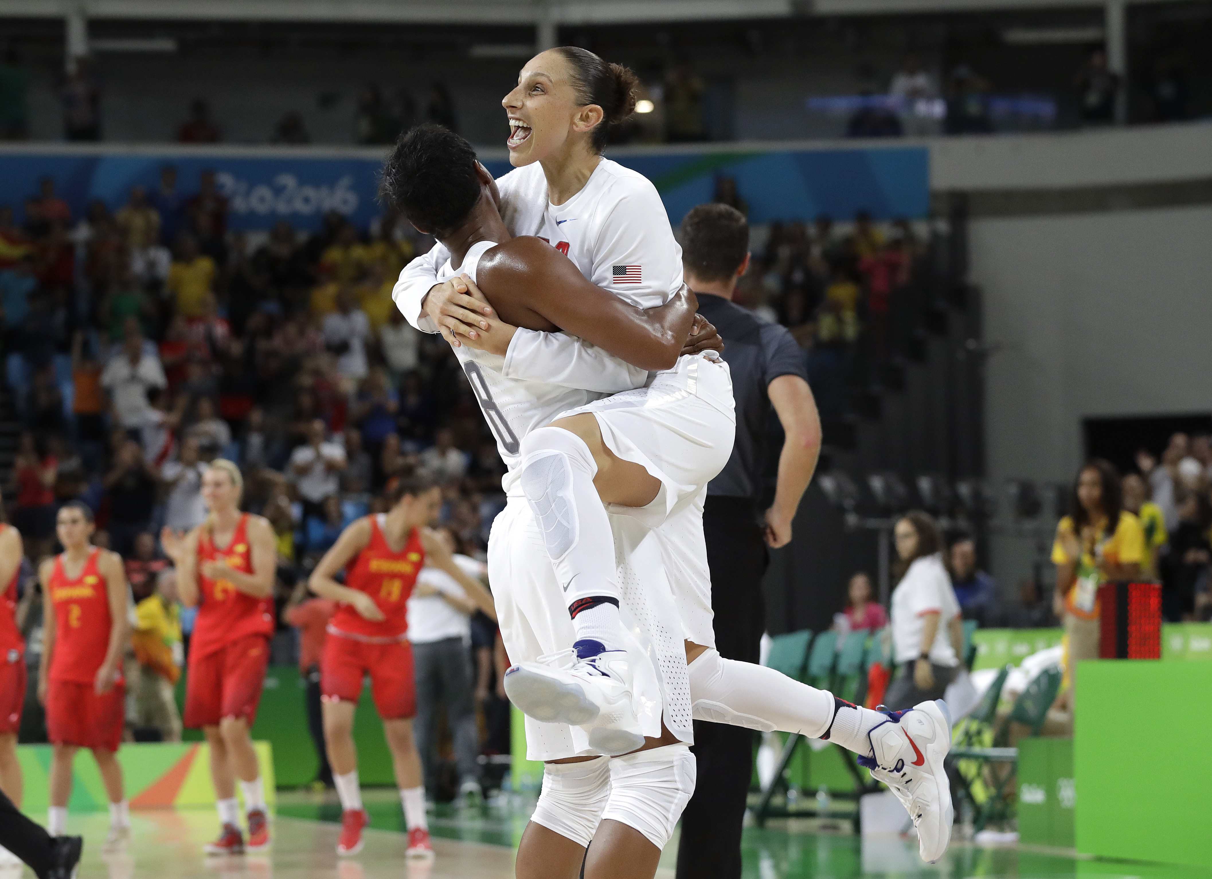 Diana Taurasi leaps into the arms of teammate Angel McCoughtry as they celebrate their win over Spain in a women's gold medal basketball game at the 2016 Summer Olympics, on Aug. 20, 2016. (Eric Gay—AP)