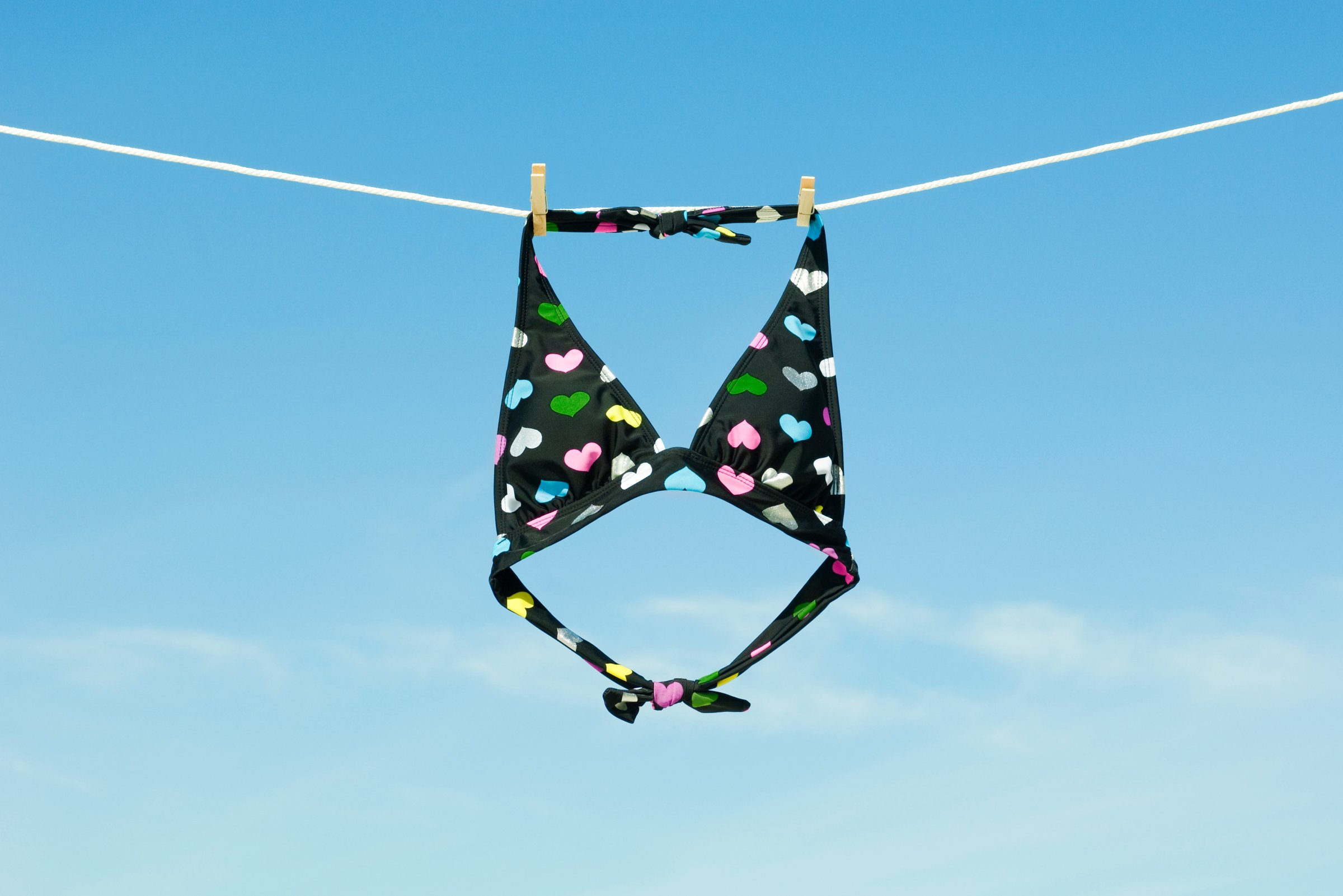 Bikini top hanging on clothes-line