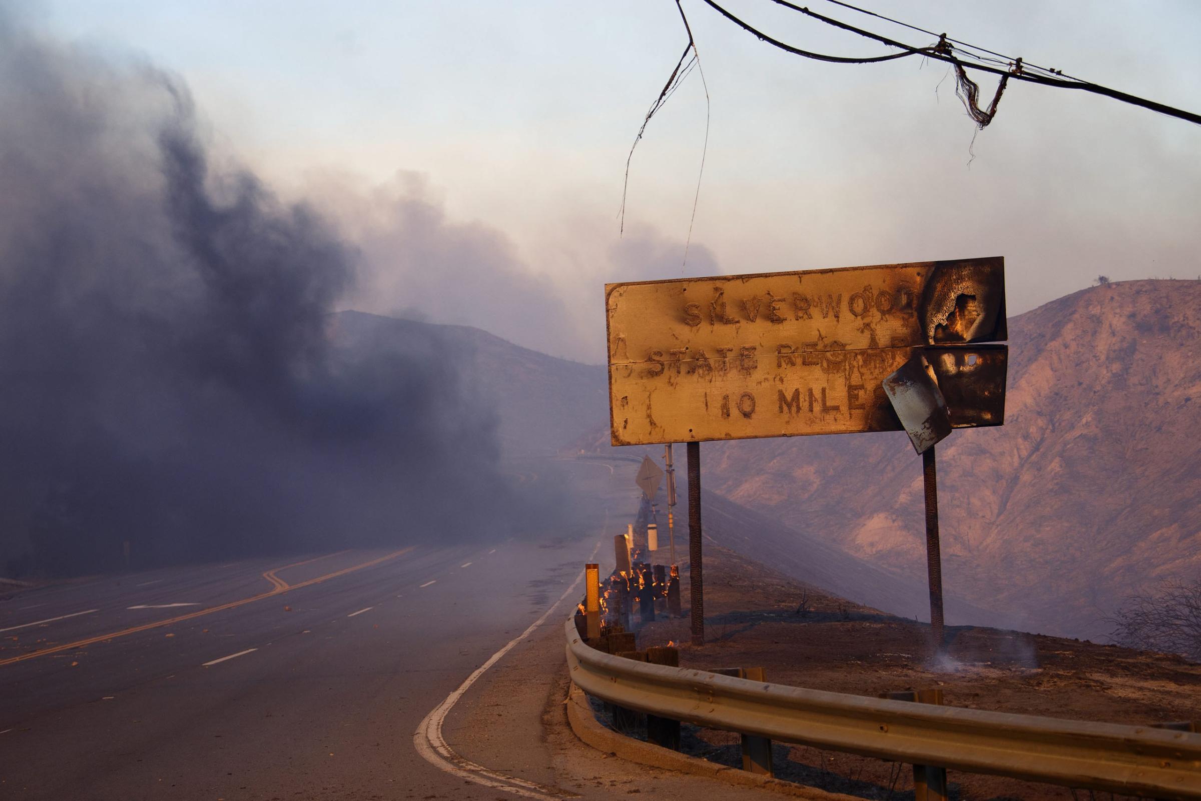 A melted sign shows the damage after a wildfire swept through Cajon Junction, Calif., Aug. 16, 2016.