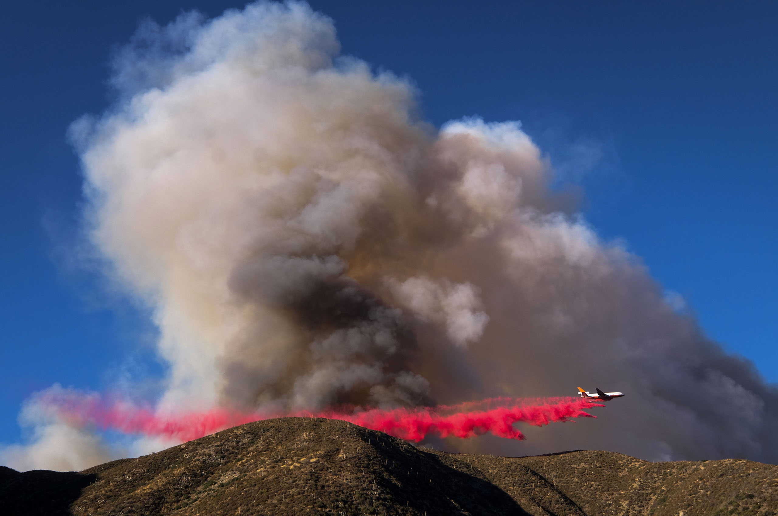 An air tanker drops fire retardant on the Blue Cut wildfire in Lytle Creek, Calif., Aug. 16, 2016.
