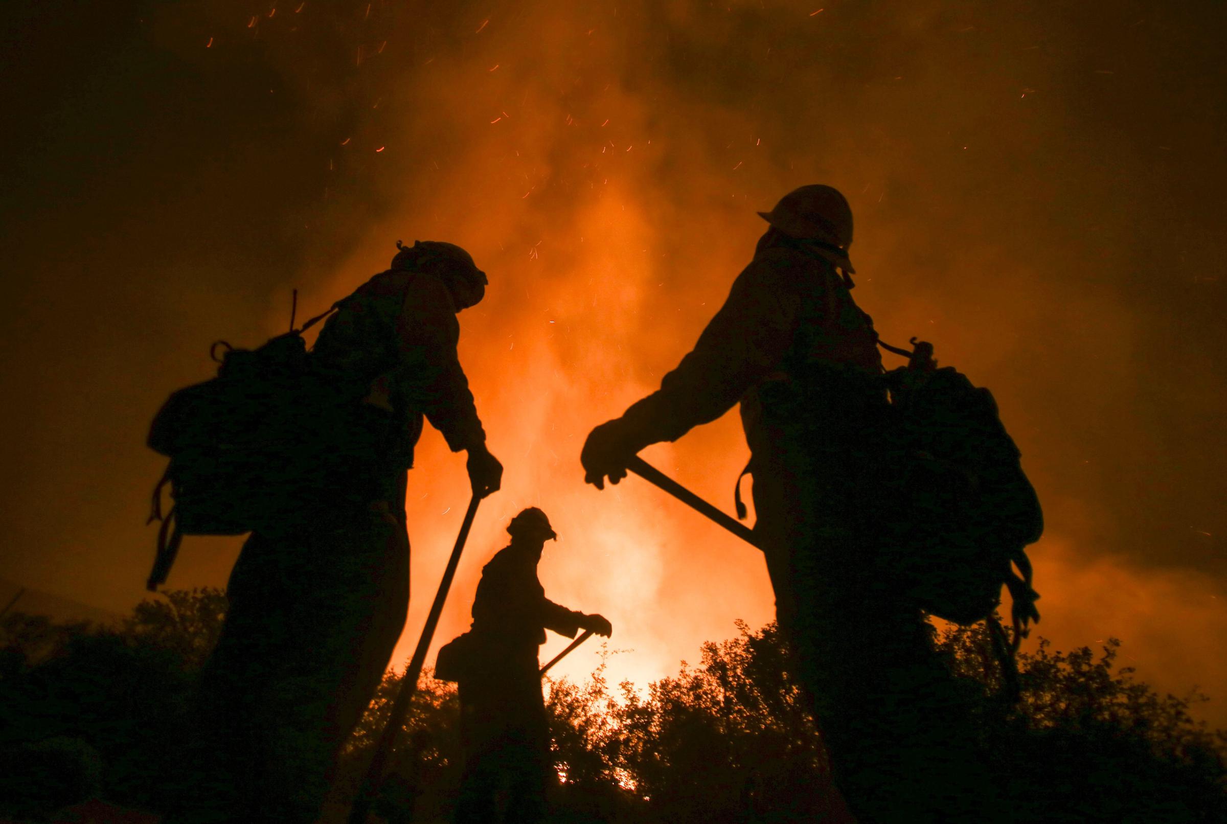 Firefighters battle the Blue Cut wildfire near Cajon Pass, north of San Bernardino, Calif., Aug. 16, 2016.